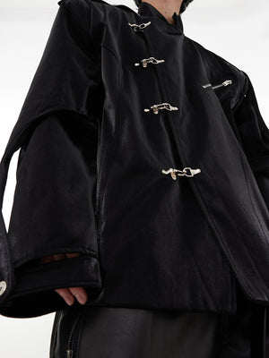 Close-up of decorative metal clasps on premium mandarin collar blazer with liquid-effect fabric