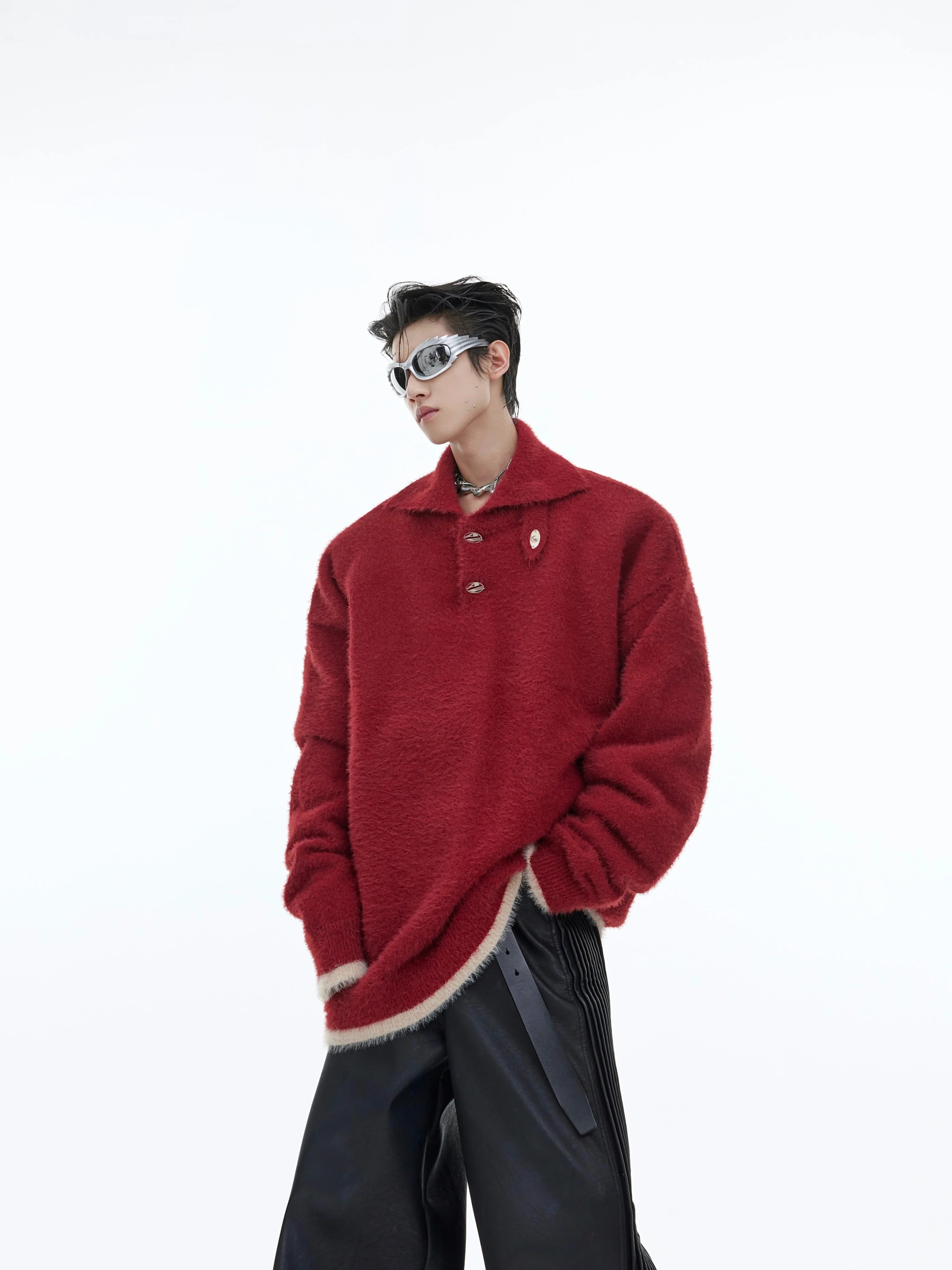 Oversized fleece pullover sweater with unique dye-splashed design and metal trim details, perfect for streetwear fashion