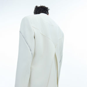 Rear view of deconstructed blazer featuring unique back design with metal zipper accents