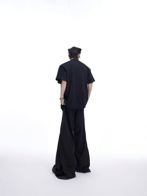 Back view of textured streetwear top featuring prominent metal zipper design and deconstructed tailoring