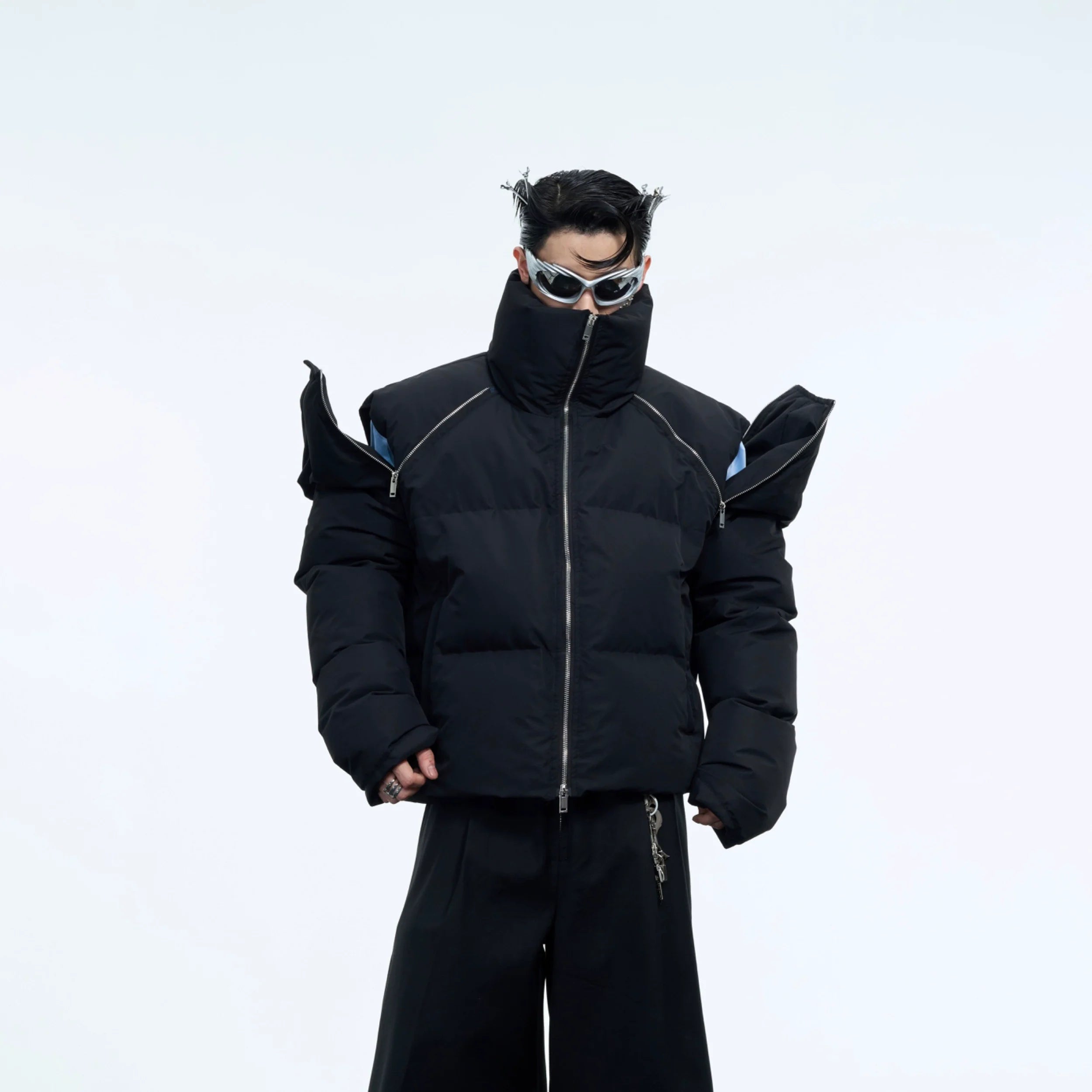 Front view of short puffer jacket with bold metal zipper detailing, showcasing urban streetwear style