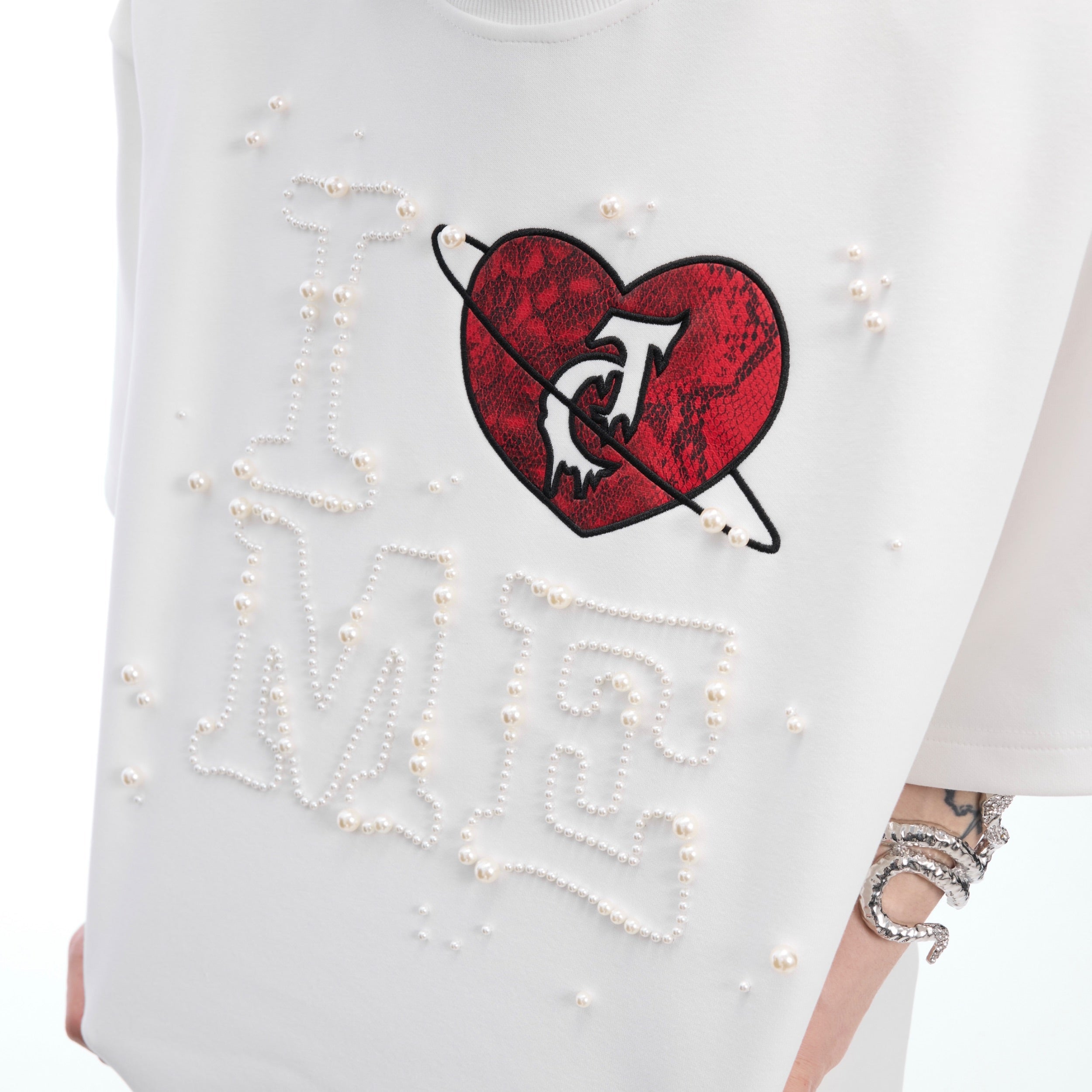 Back view of minimalist oversized tee featuring metallic design elements for couples
