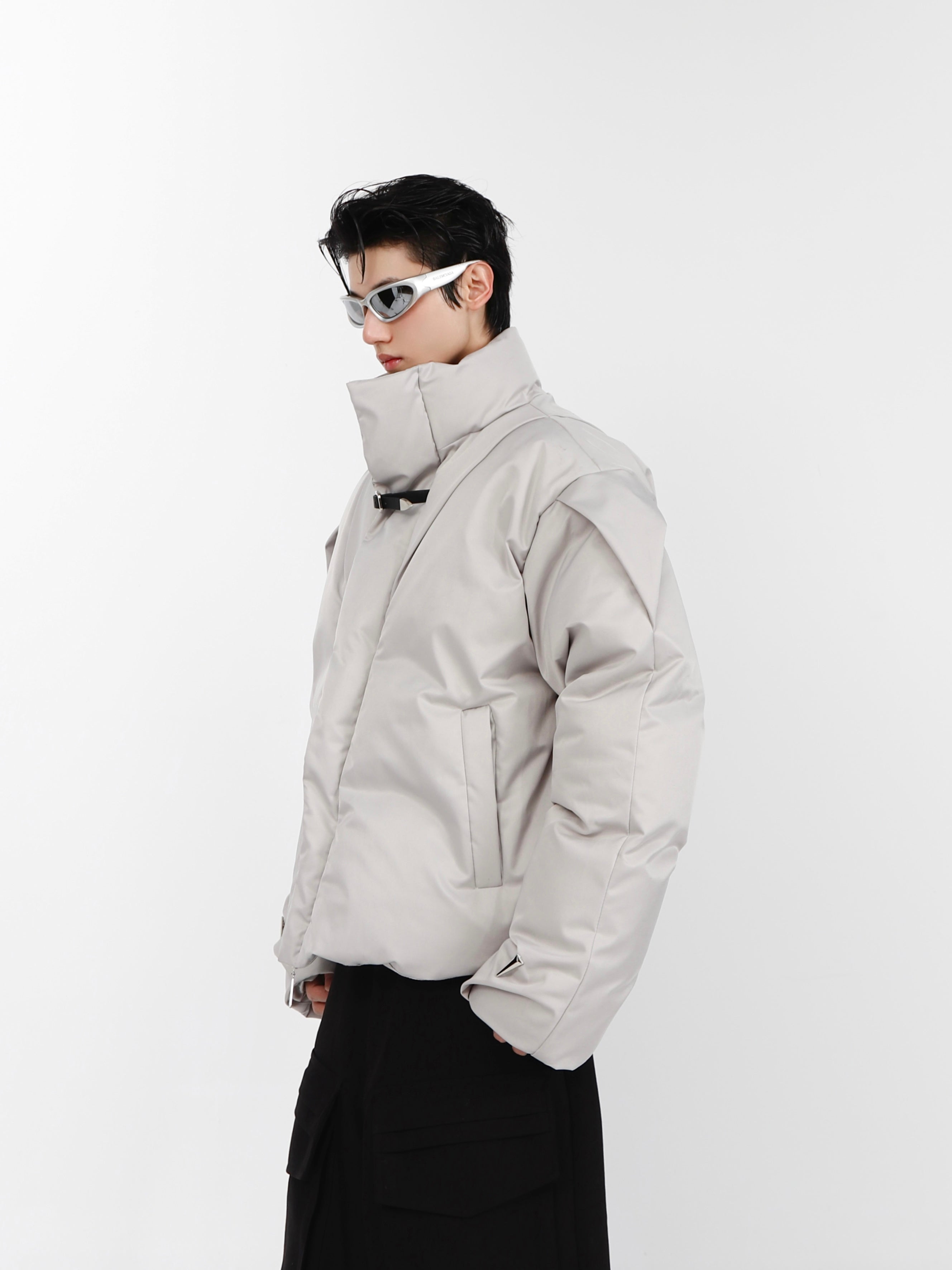 Side profile view of minimalist cotton jacket highlighting its sleek, architectural silhouette