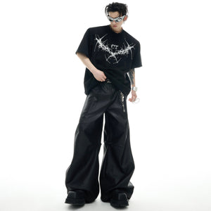 Stylish model wearing the black oversized streetwear tee with metal stud accents for urban fashion
