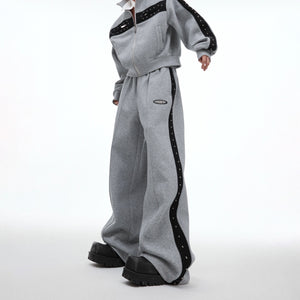 Full body shot of model wearing complete deconstructed pleated streetwear set with loose fit design