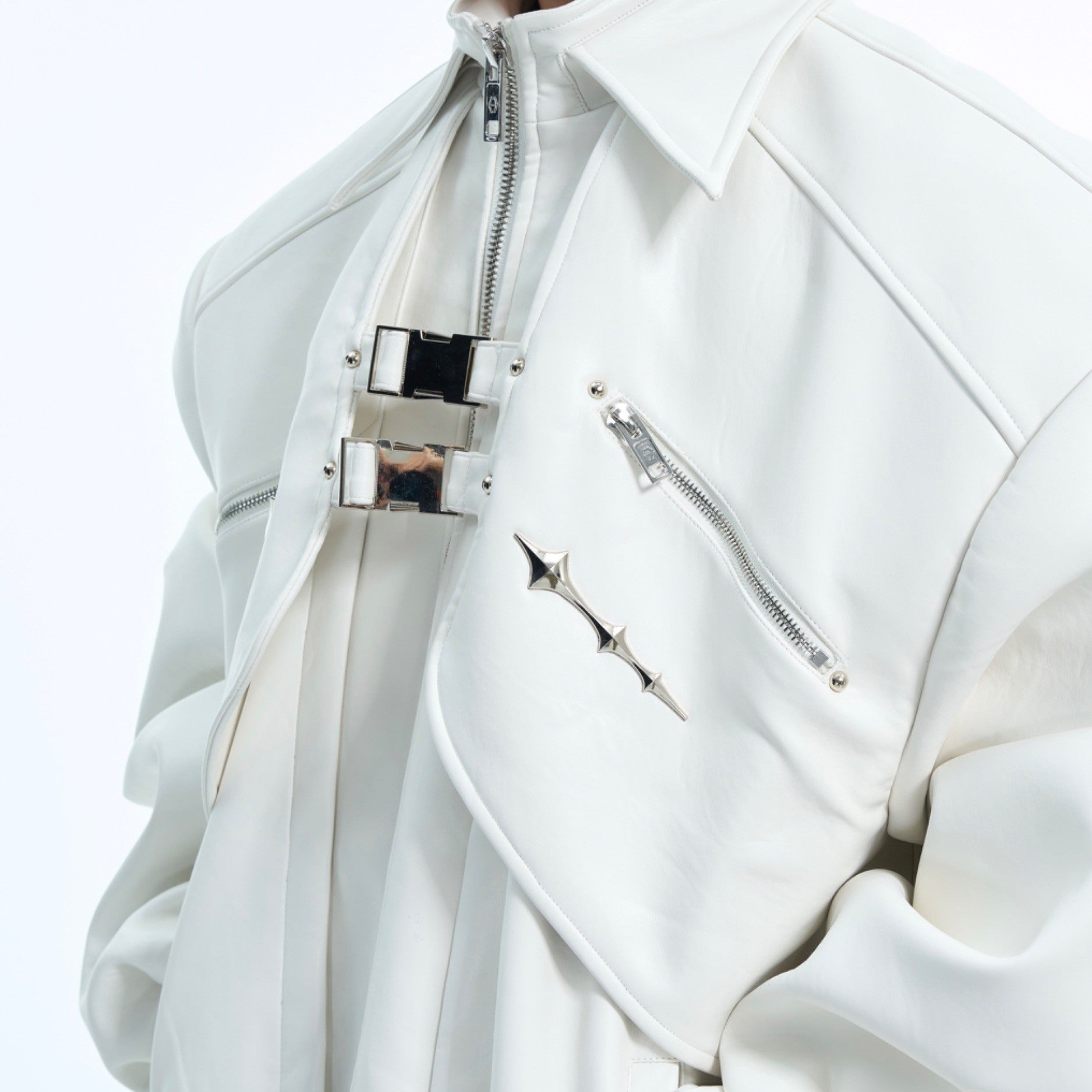 Close-up of industrial metal buckles and hardware on edgy deconstructed leather jacket