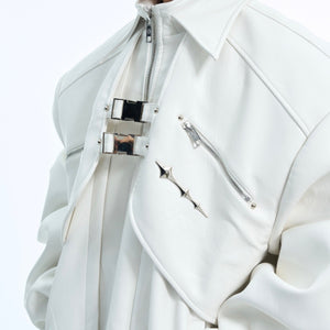 Close-up of industrial metal buckles and hardware on edgy deconstructed leather jacket