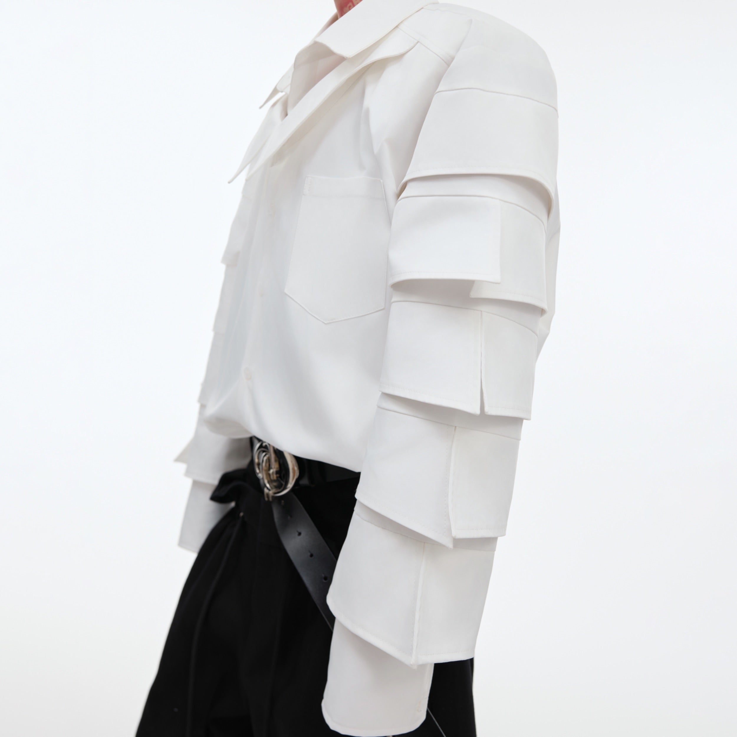 Detailed view of the deconstructed shoulder pad design in this modern streetwear shirt