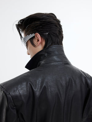 Back view of deconstructed leather blazer highlighting its unique belt detailing and urban edge