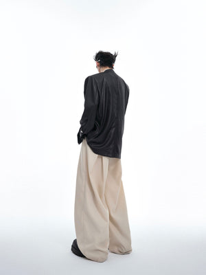 Folded view showcasing the unique liquid metal texture and oversized fit of this contemporary blazer
