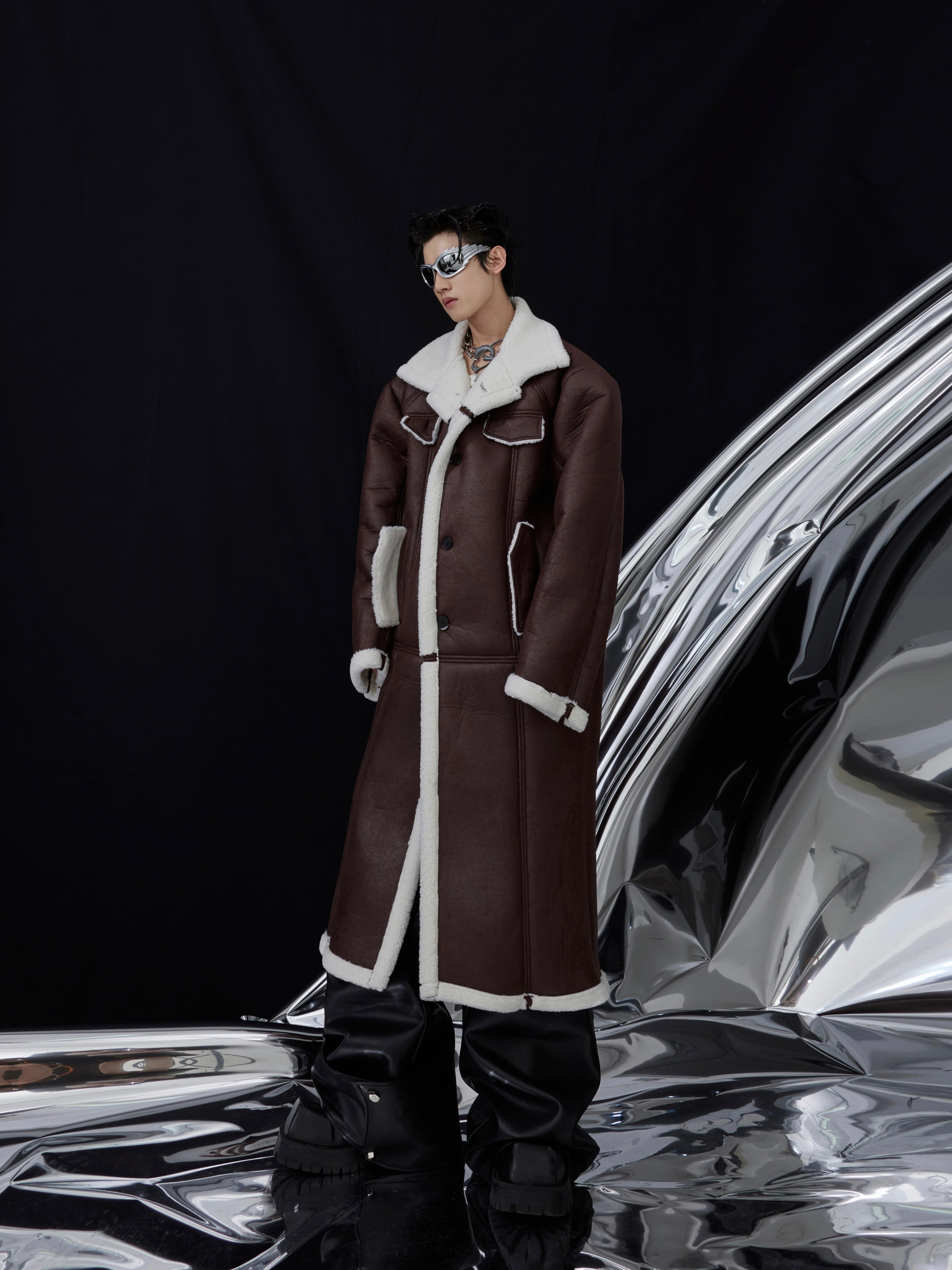 Oversized faux fur jacket featuring bold surface pleats and topstitching details for an edgy urban look
