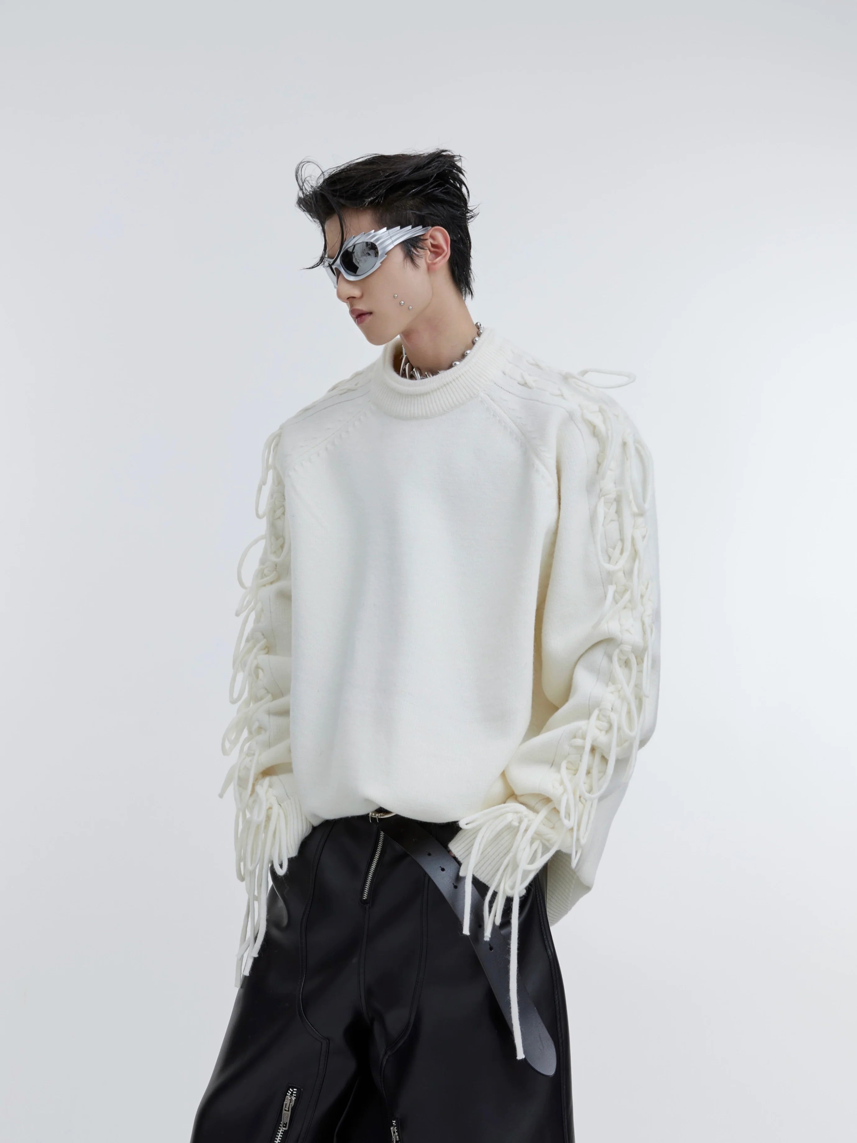 Front view of oversized deconstructed fringe knit sweater being worn, showing slouchy streetwear style