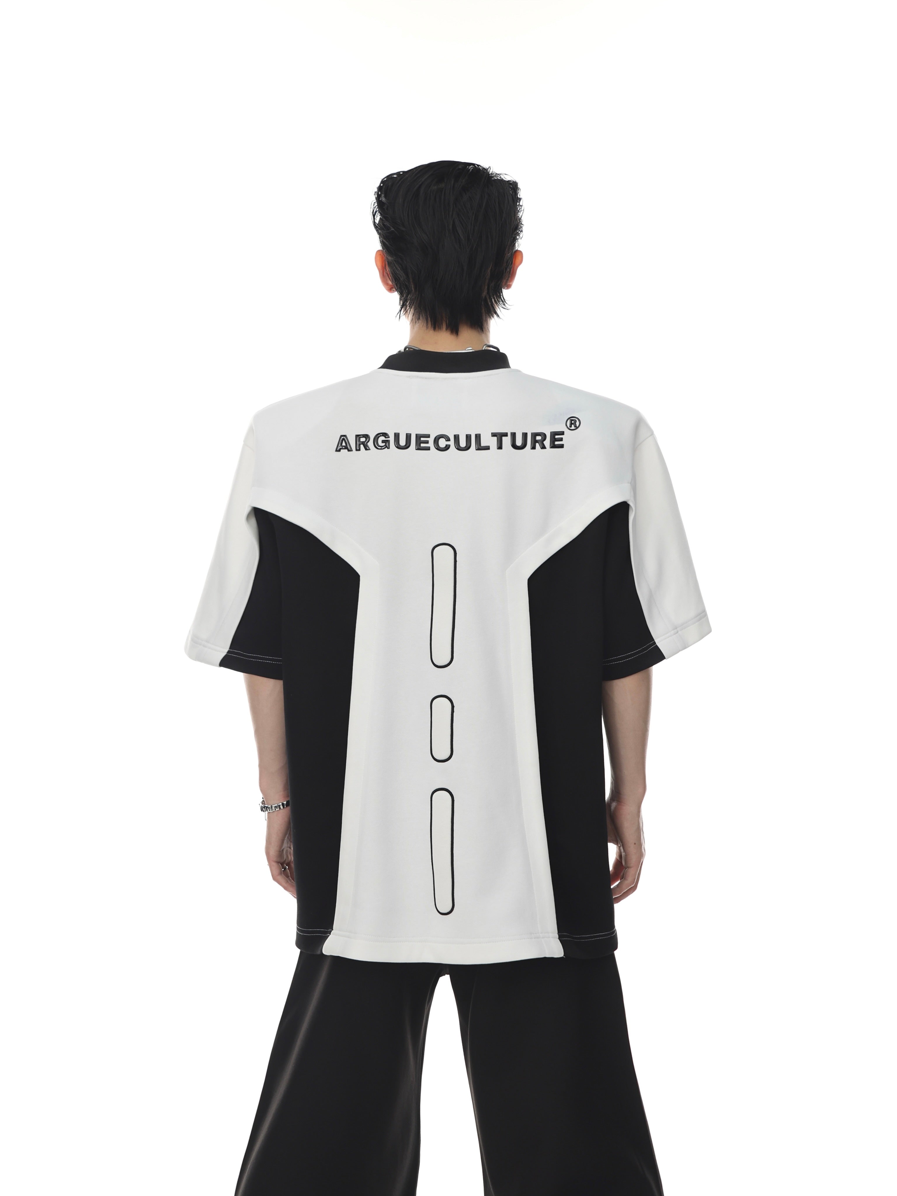 Oversized graphic tee with padded shoulders, featuring bold geometric print and urban streetwear style