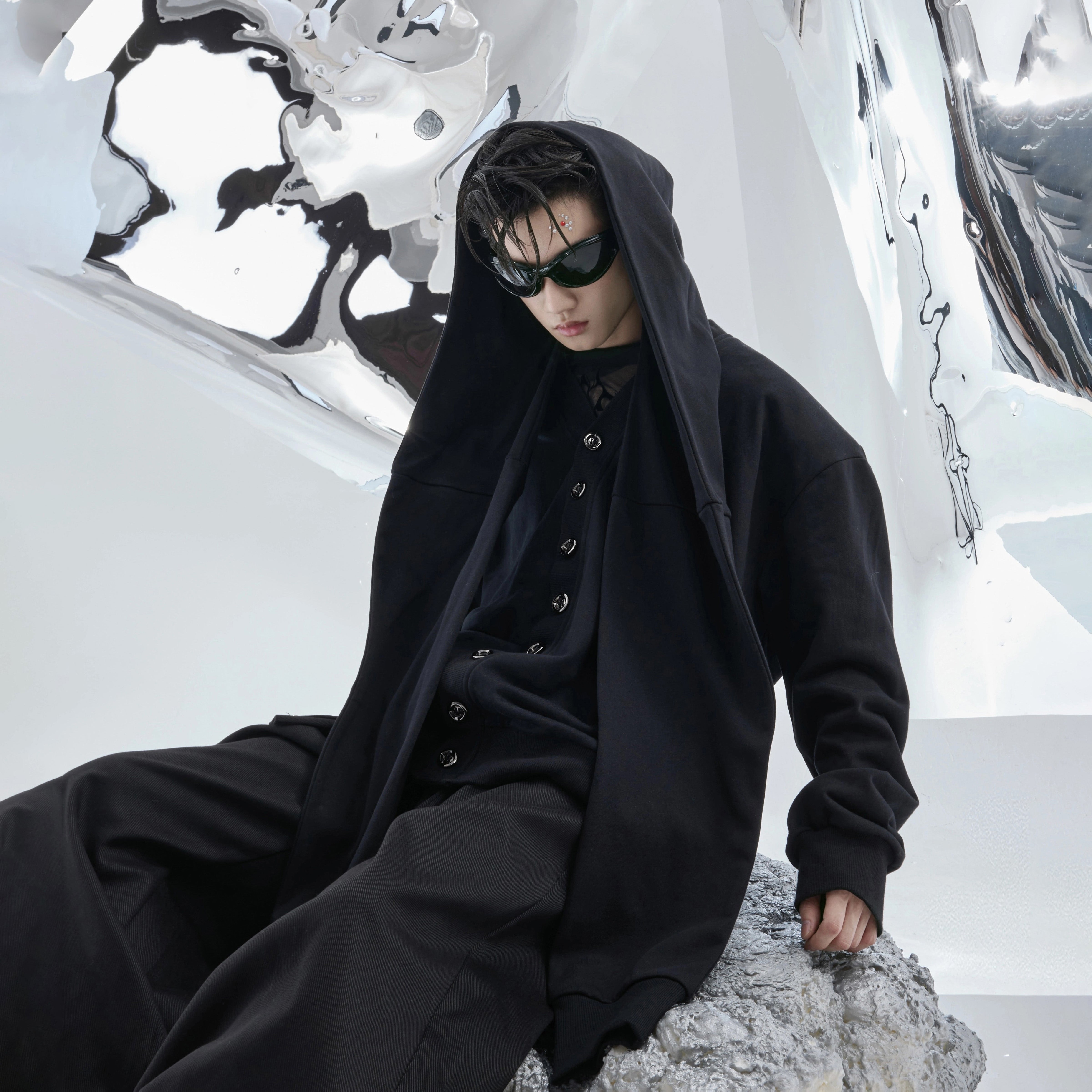 Front view of oversized hooded sweatshirt with detachable zip-up design and drop shoulder streetwear style
