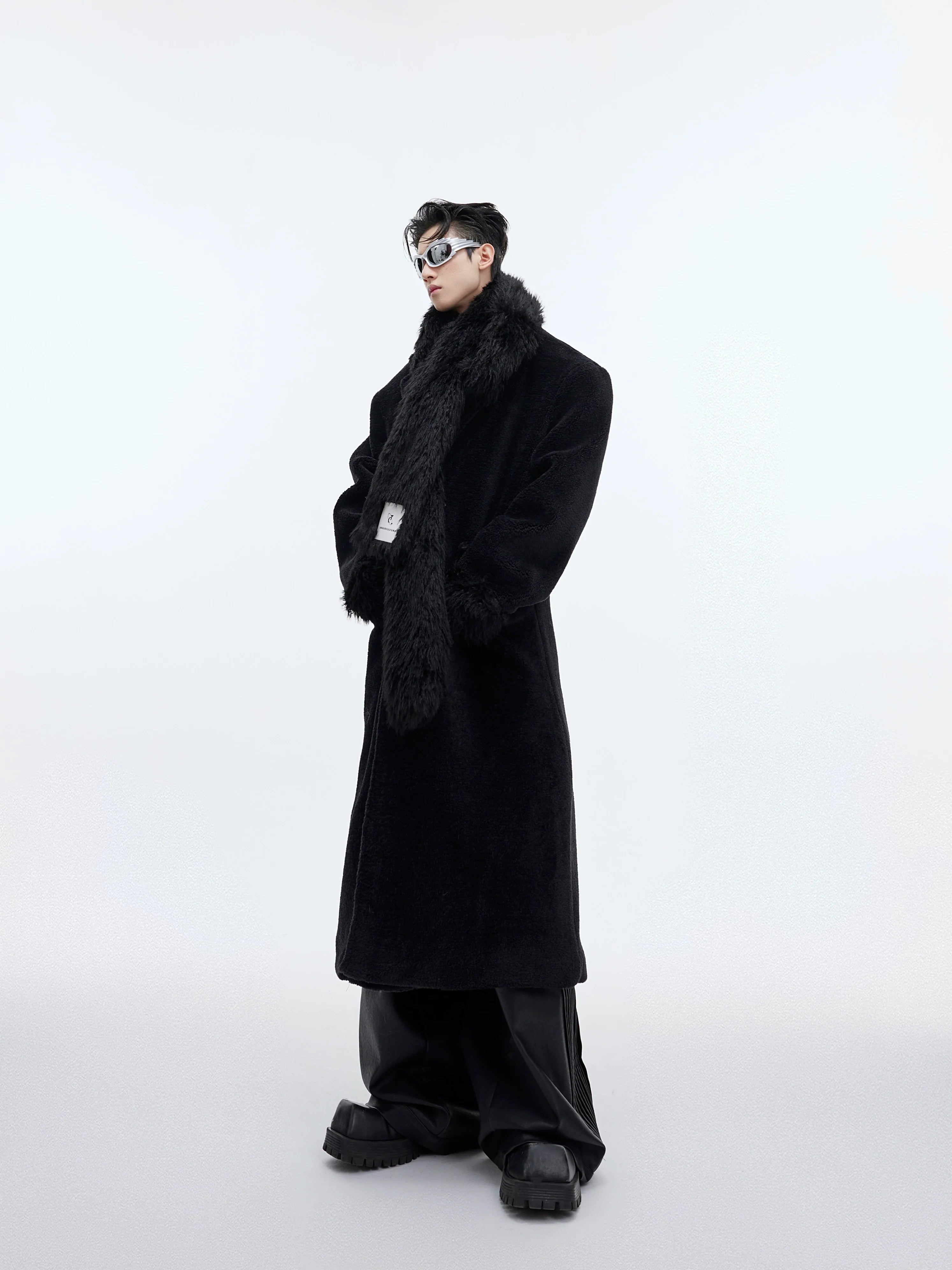 Men's oversized plaid wool coat featuring bold patchwork design and long trench silhouette for streetwear fashion