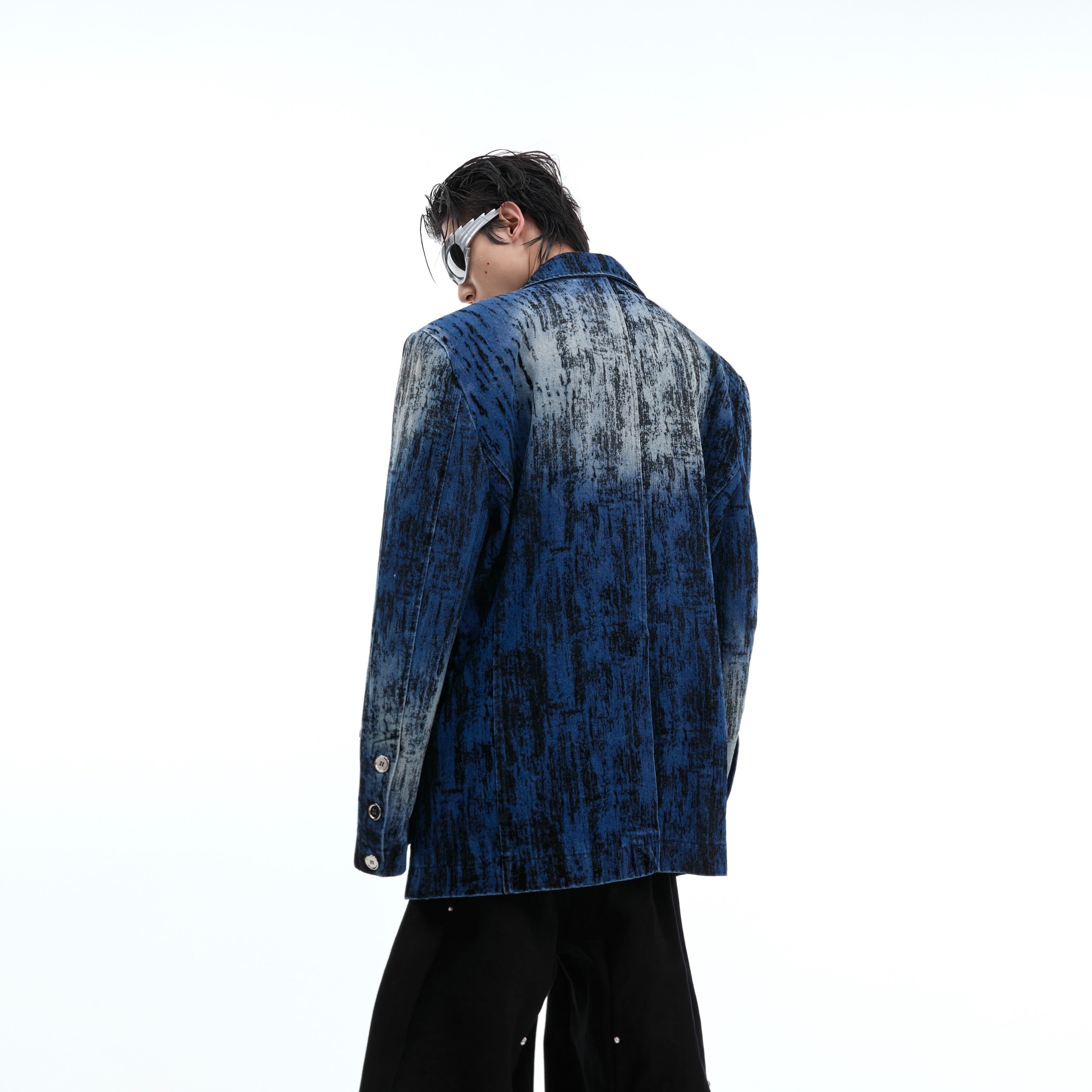 Back view showing deconstructed tailoring and metal hardware accents on this urban streetwear blazer