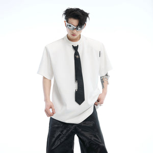 Model wearing oversized streetwear tee showing relaxed dropped shoulder cut and urban silhouette with tie accents