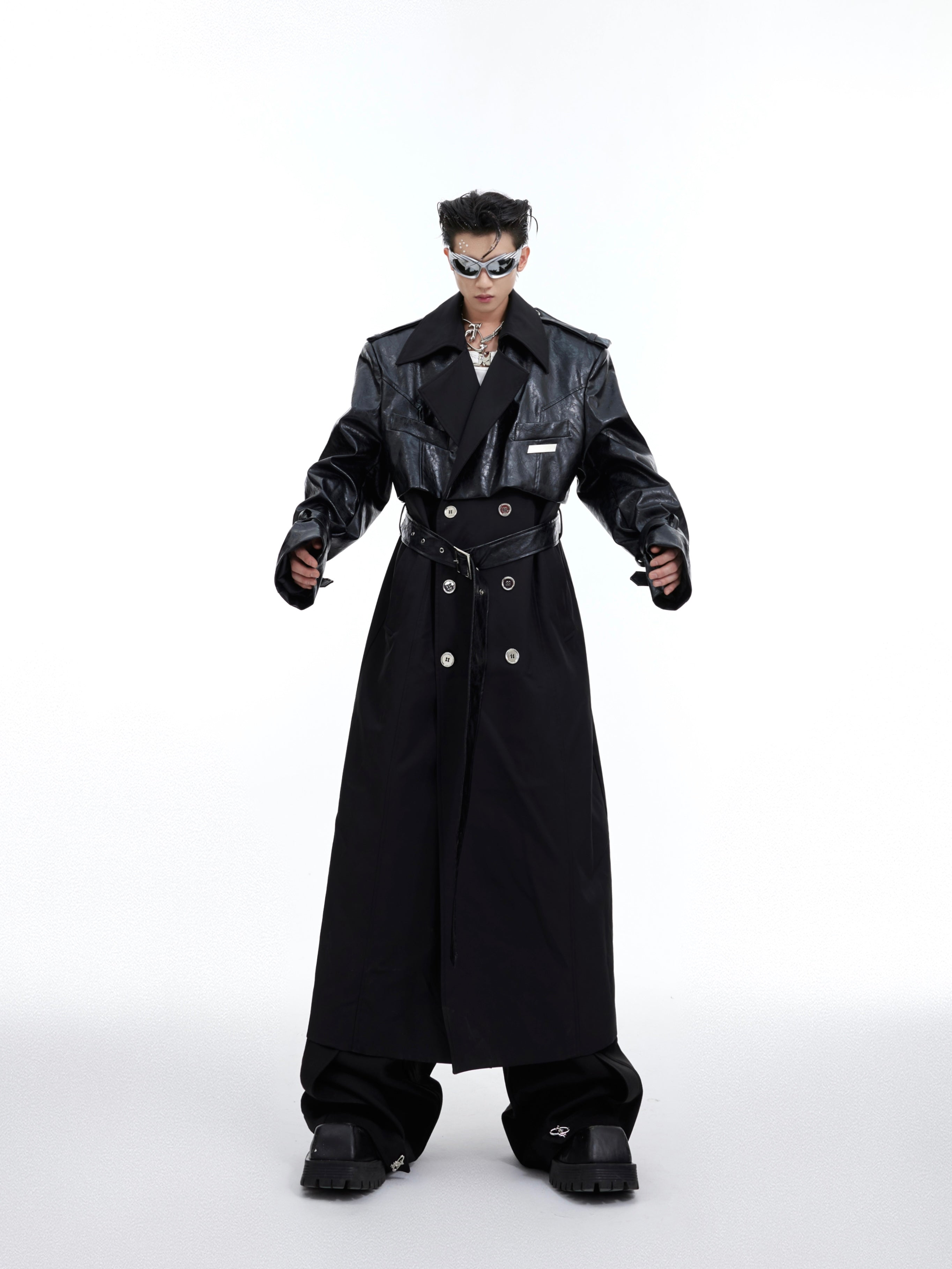 Fashion-forward long coat showcasing intricate patchwork construction and layered design elements