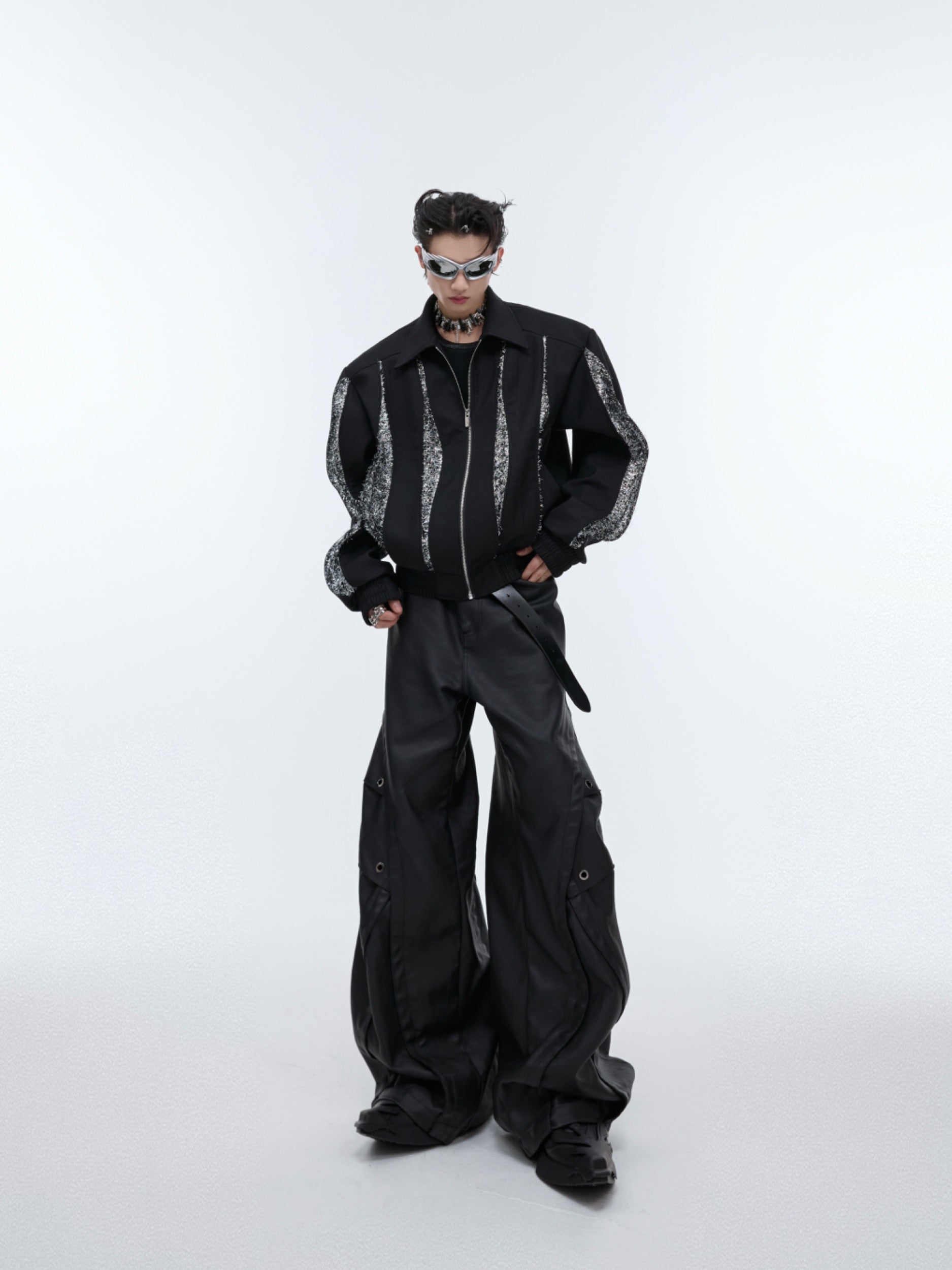 Luxurious black patchwork jacket with deconstructed design elements and premium construction