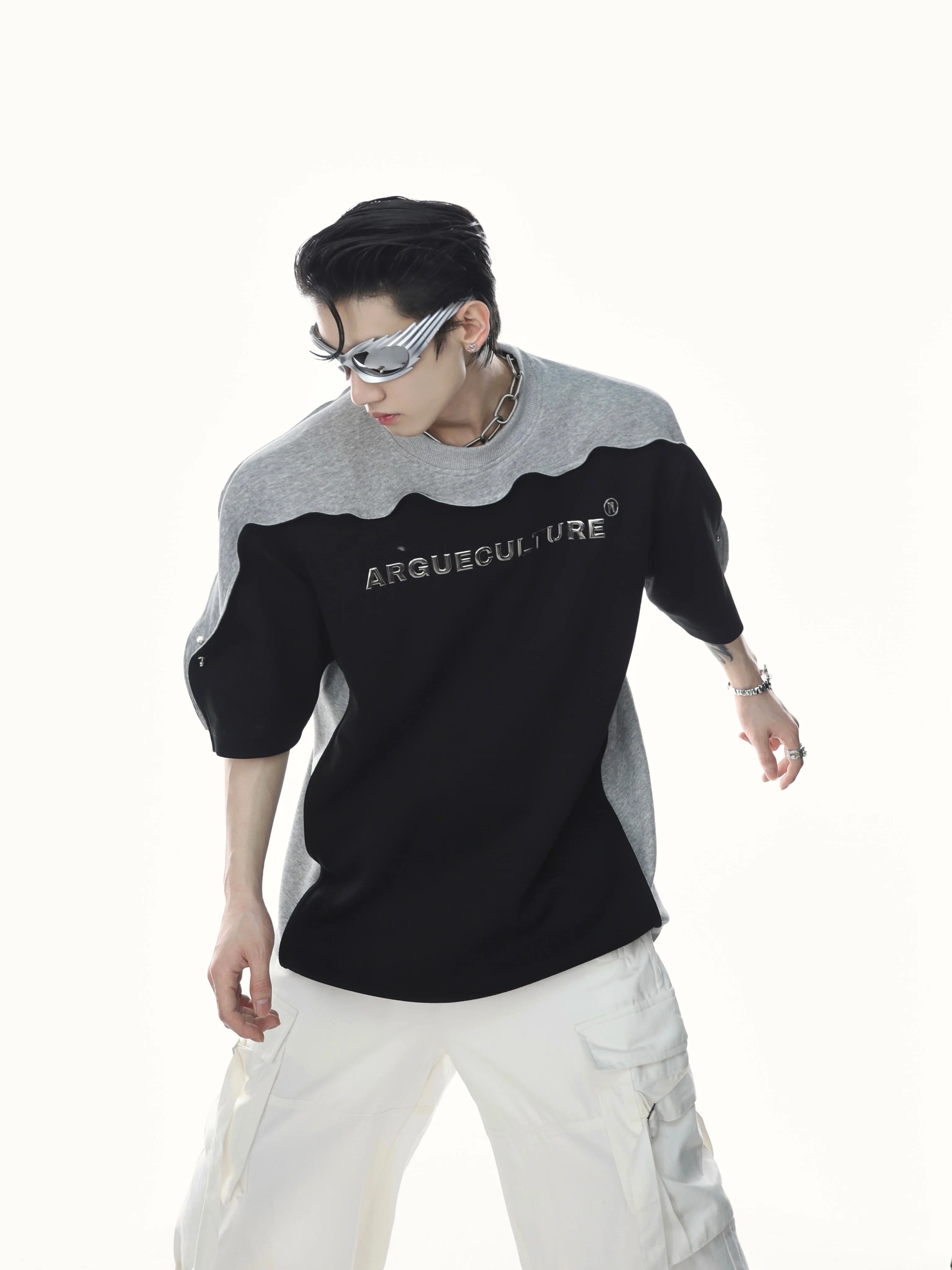 Edgy patchwork tee featuring bold 3D metallic print and unique wave sleeve design for streetwear fashion