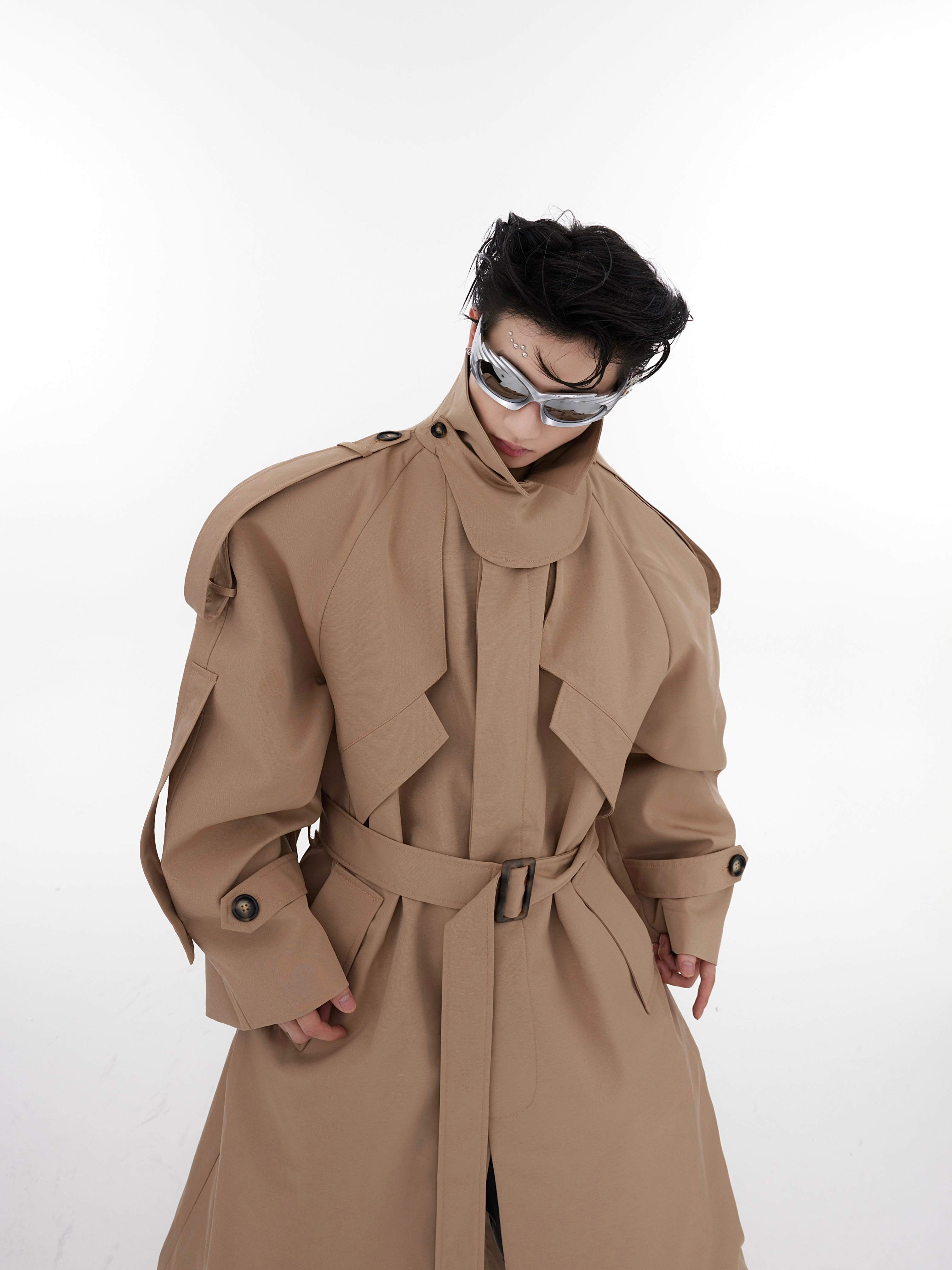 Close-up of high-quality fabric and construction details on avant-garde long trench coat