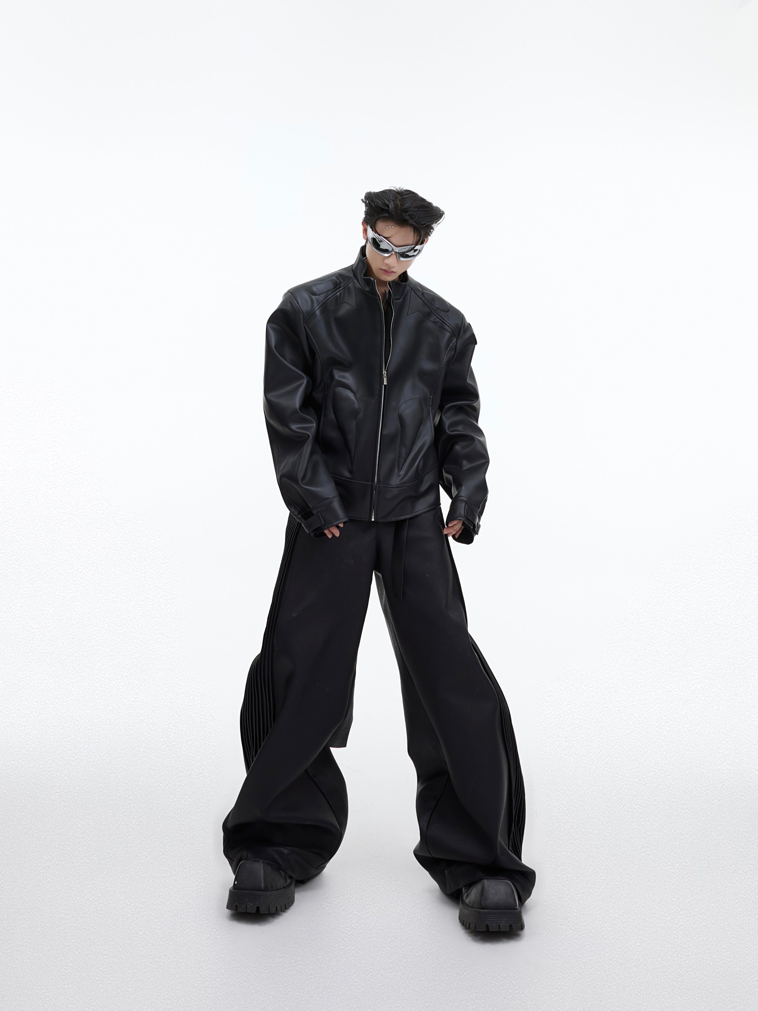 Back view of stylish cropped jacket featuring bold 3D metal triangle detailing on PU leather