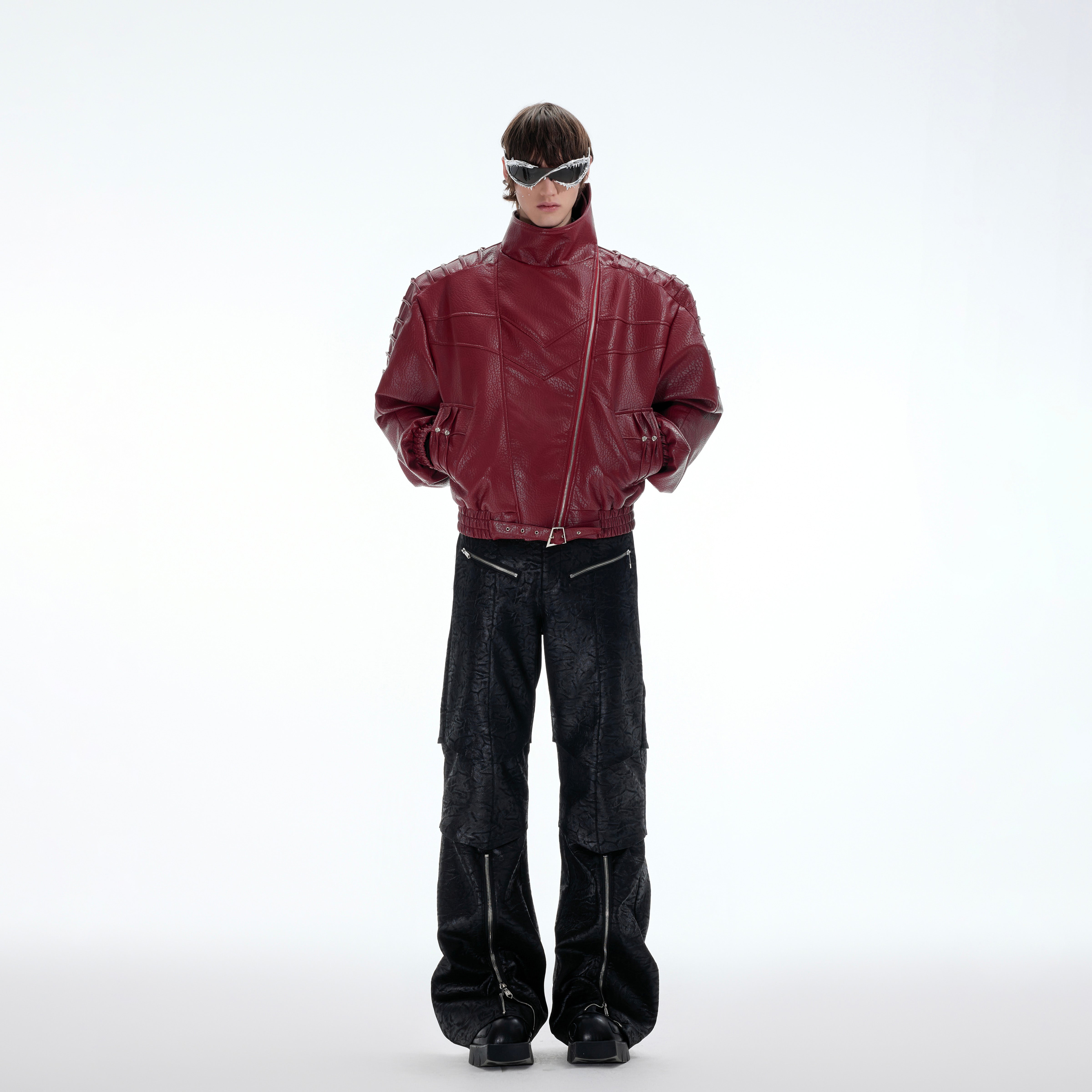 Stylish streetwear model wearing deconstructed spine-wrinkle jacket with metal studs