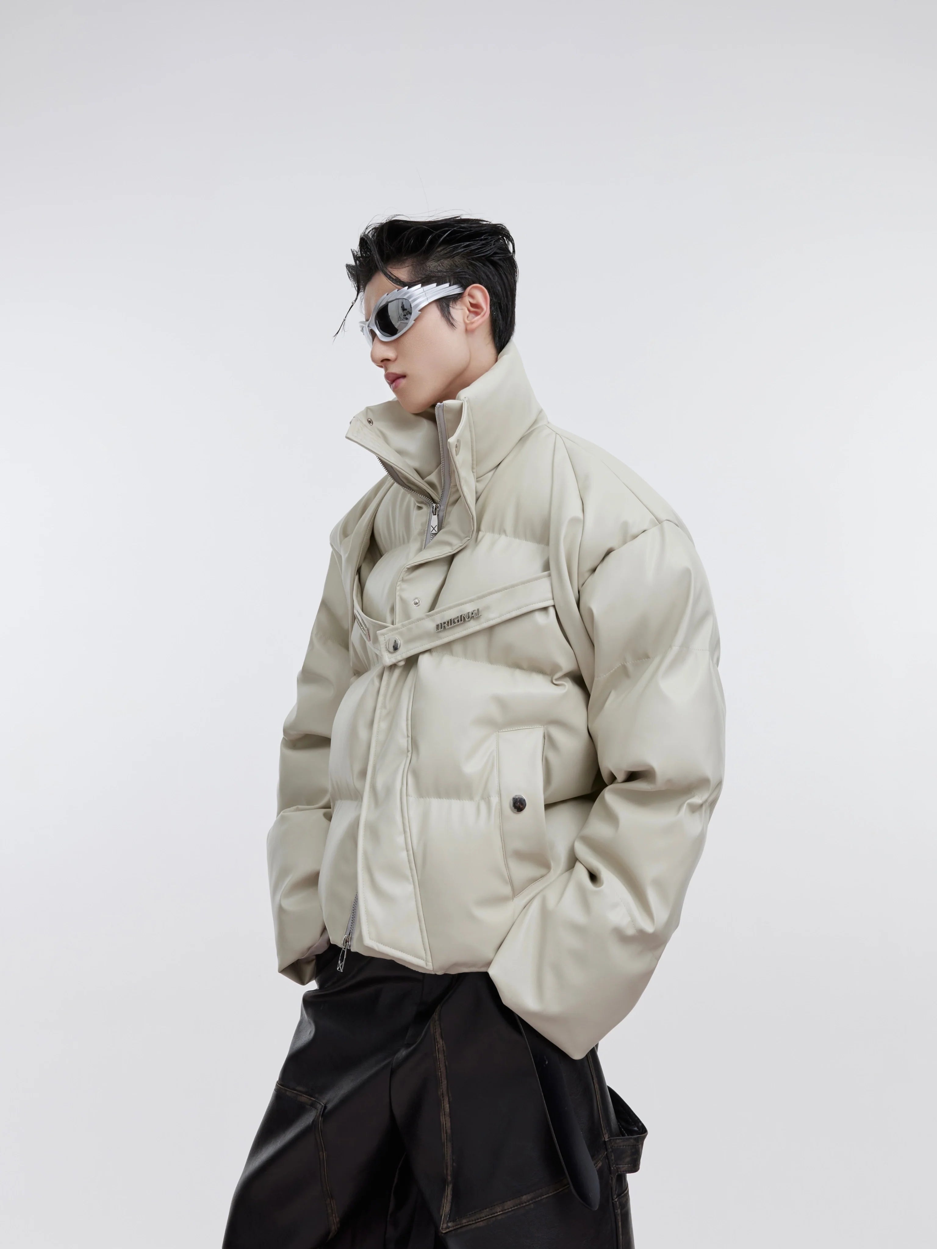 Front view of deconstructed PU puffer jacket with stylish metal straps, perfect for winter streetwear fashion