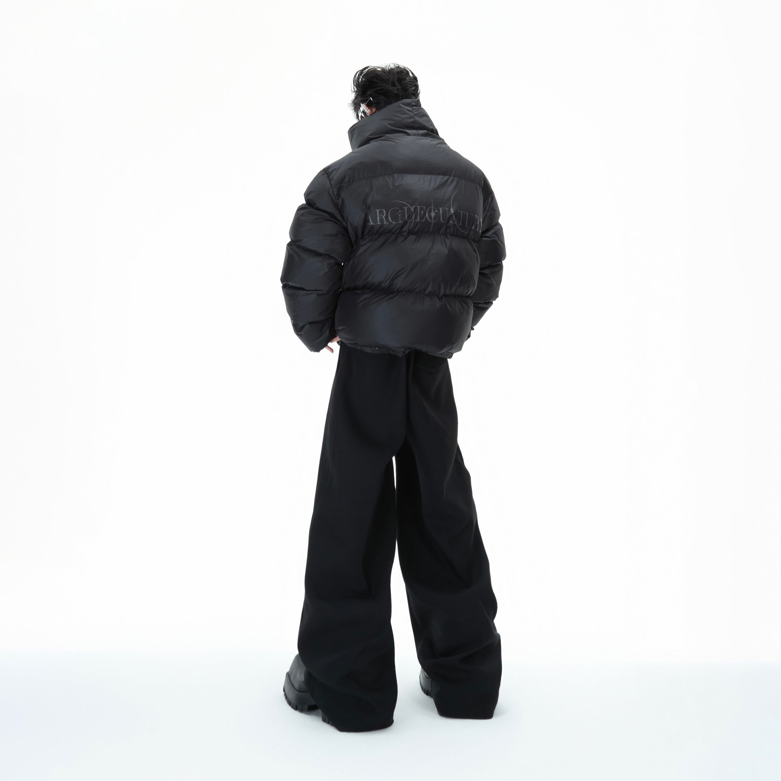 Back view of urban streetwear puffer jacket featuring high neck design and oversized silhouette