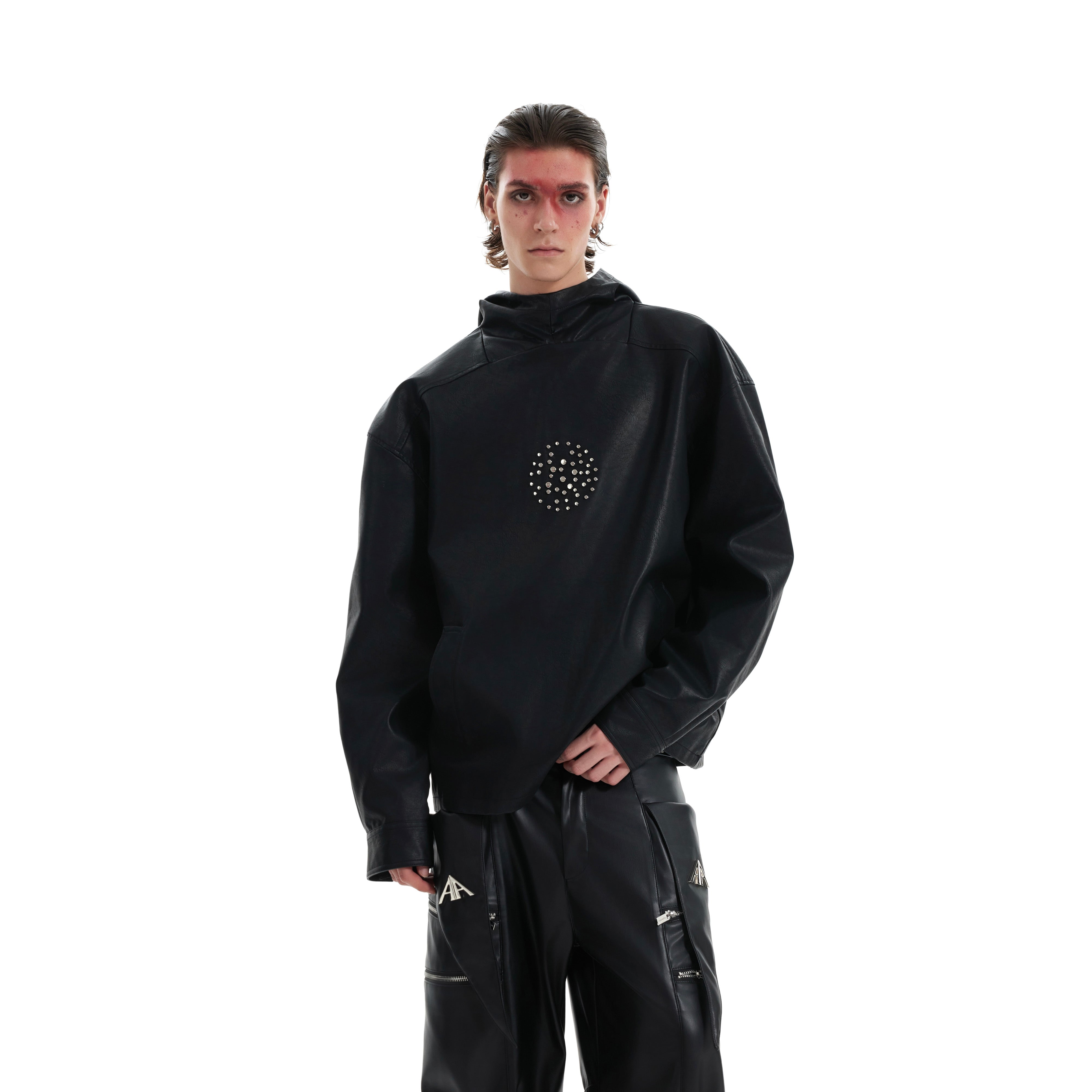 Black punk hooded PU leather jacket with metal studs, showing oversized fit and dark streetwear aesthetic