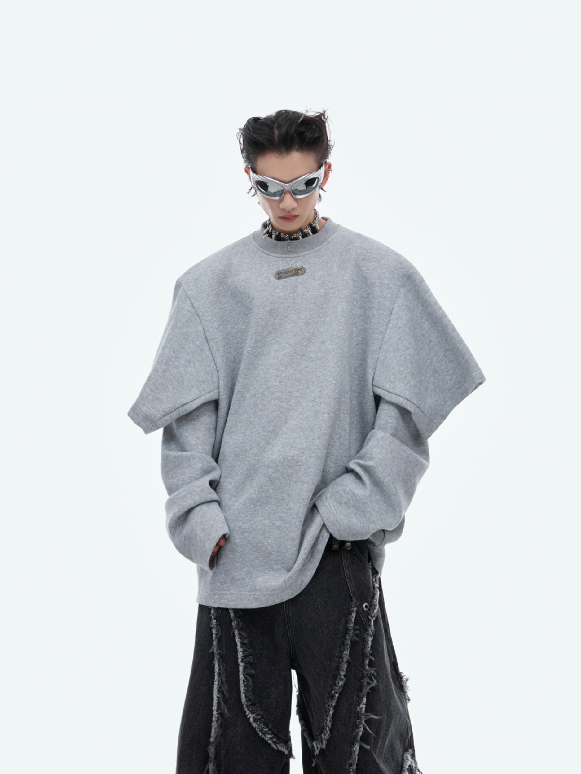 Close-up detail of radical deconstructed stitching and raw edges on this oversized drop-shoulder hoodie