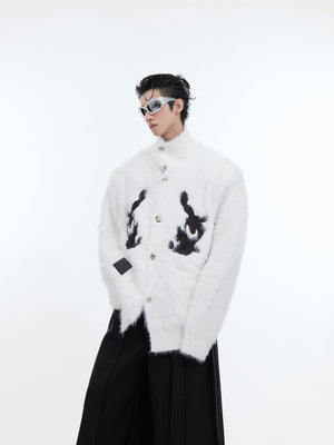 Side view of red plush knit cardigan showing unique patchwork deconstructed design details