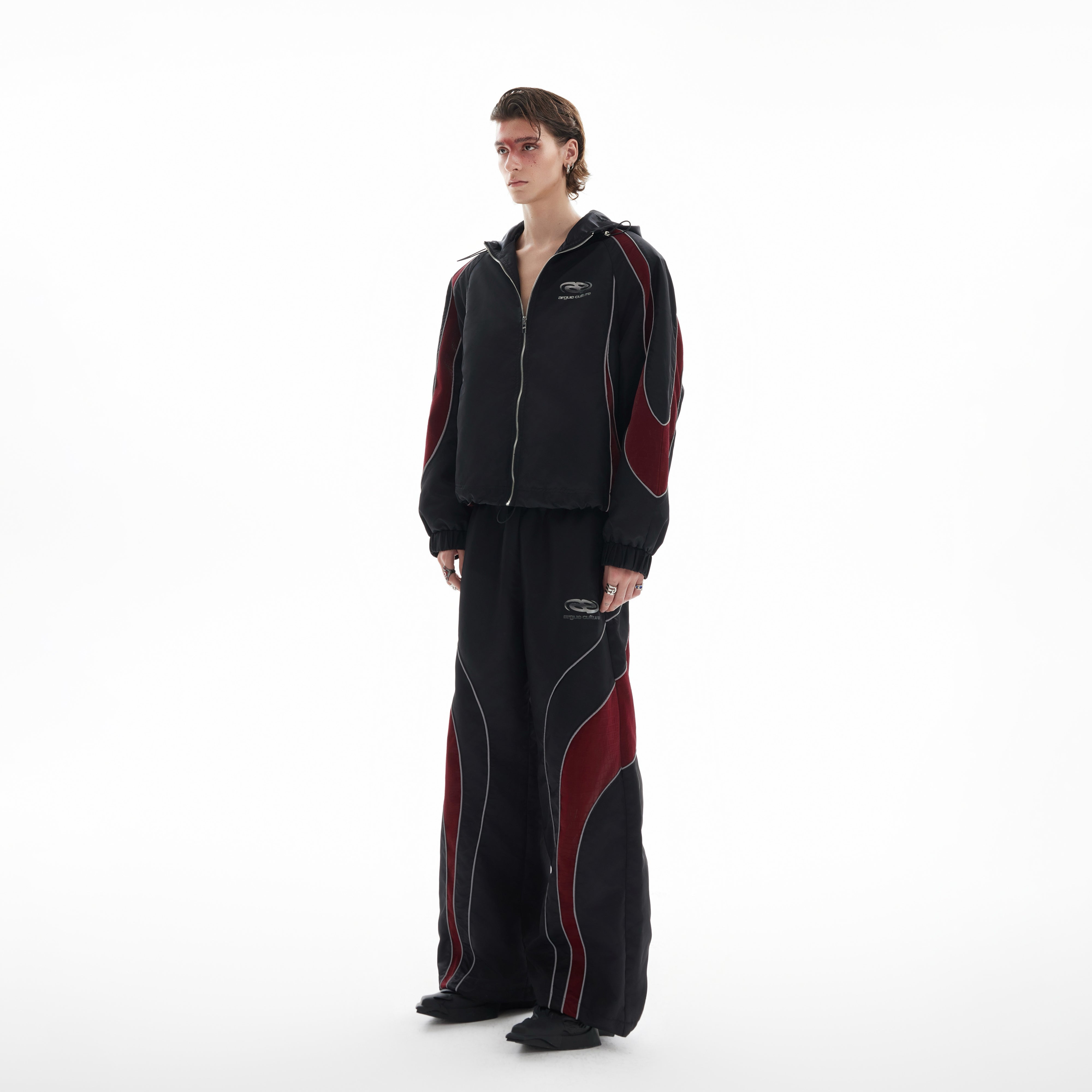 Front view of reflective color-block hooded windbreaker with sporty streetwear design and futuristic edge