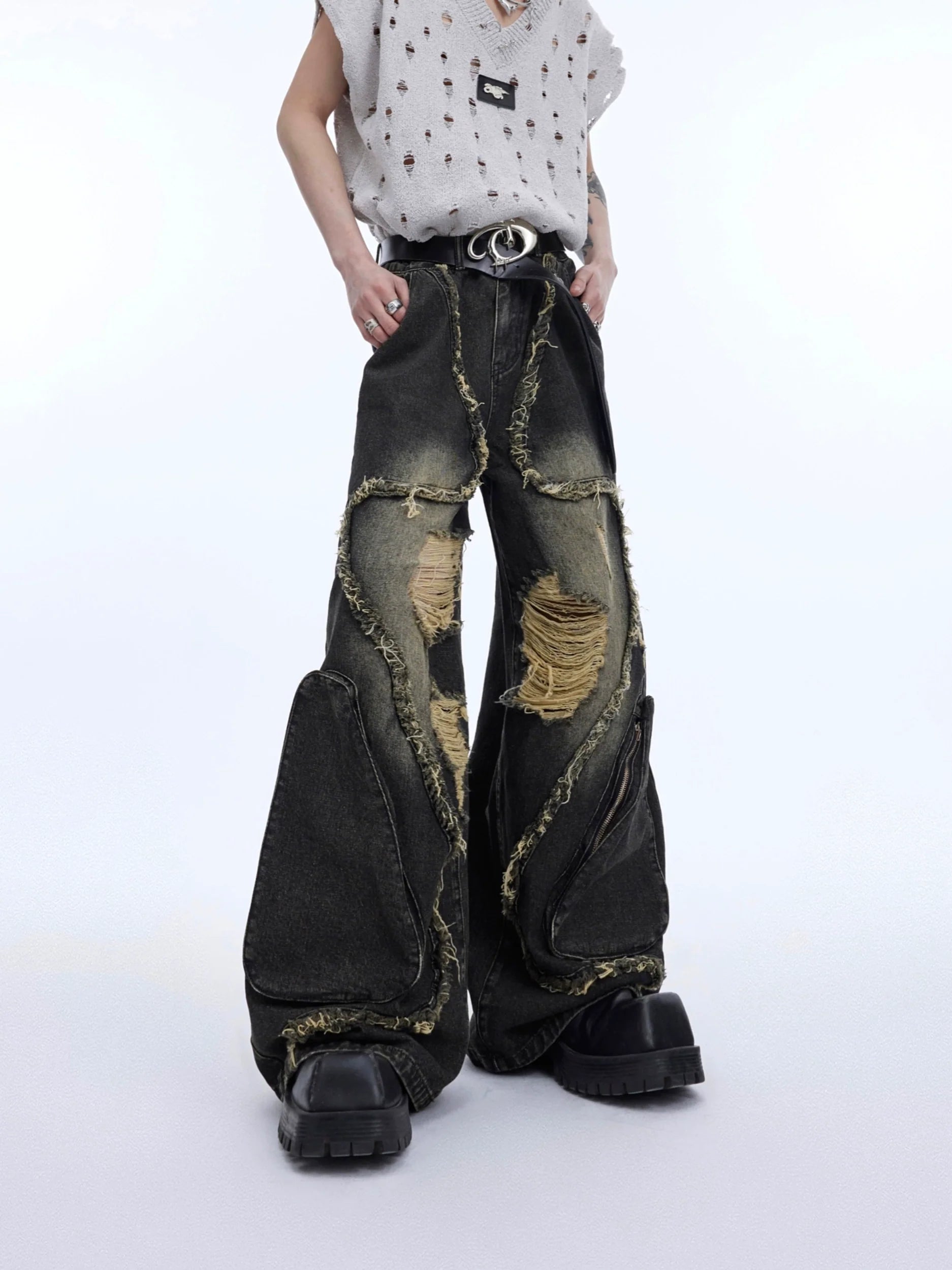 Vintage washed deconstructed jeans with handcrafted fringe detailing and strategic rips for edgy streetwear style