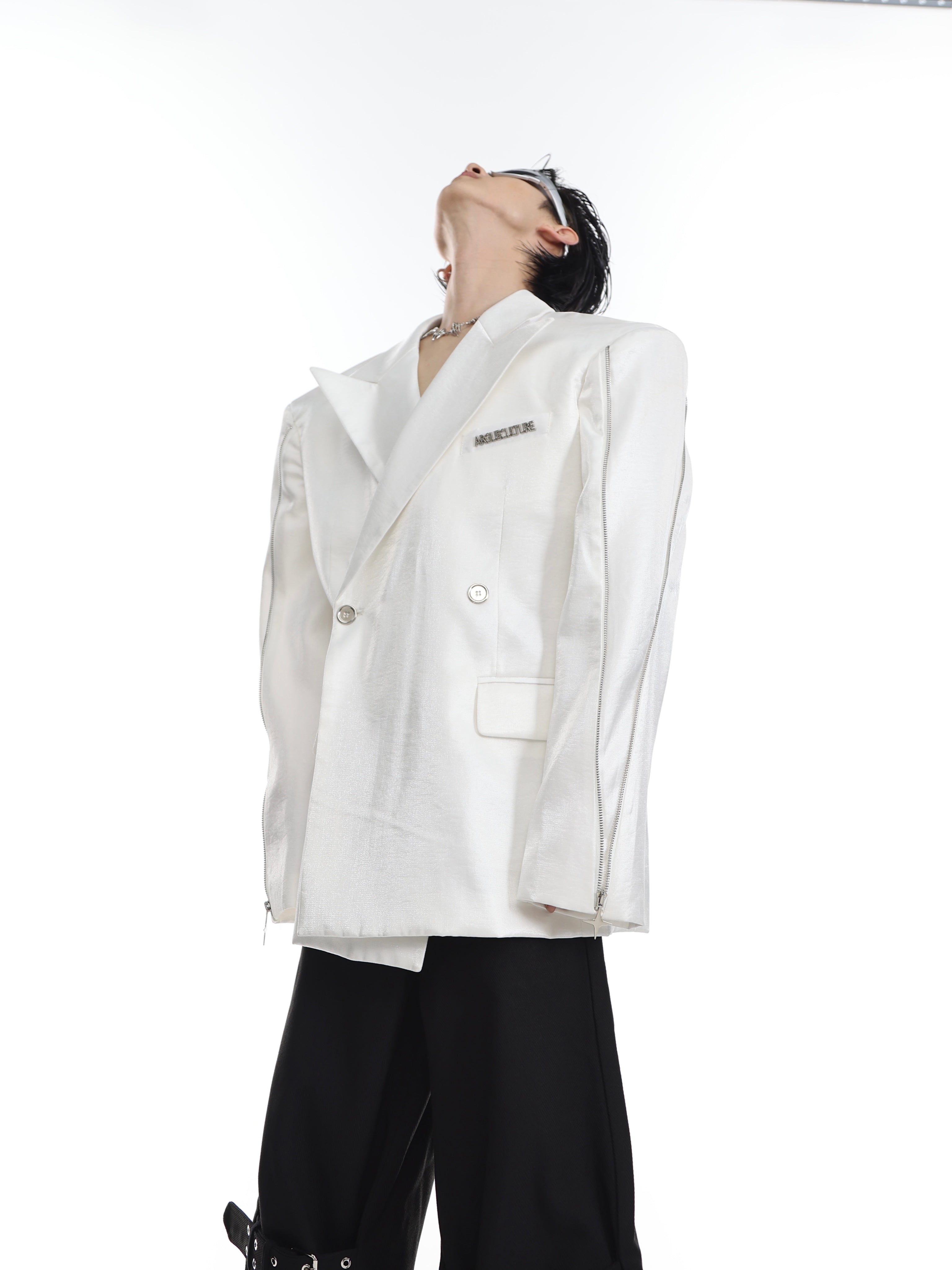 Close-up of the high-fashion metallic zipper detail on this contemporary streetwear blazer.