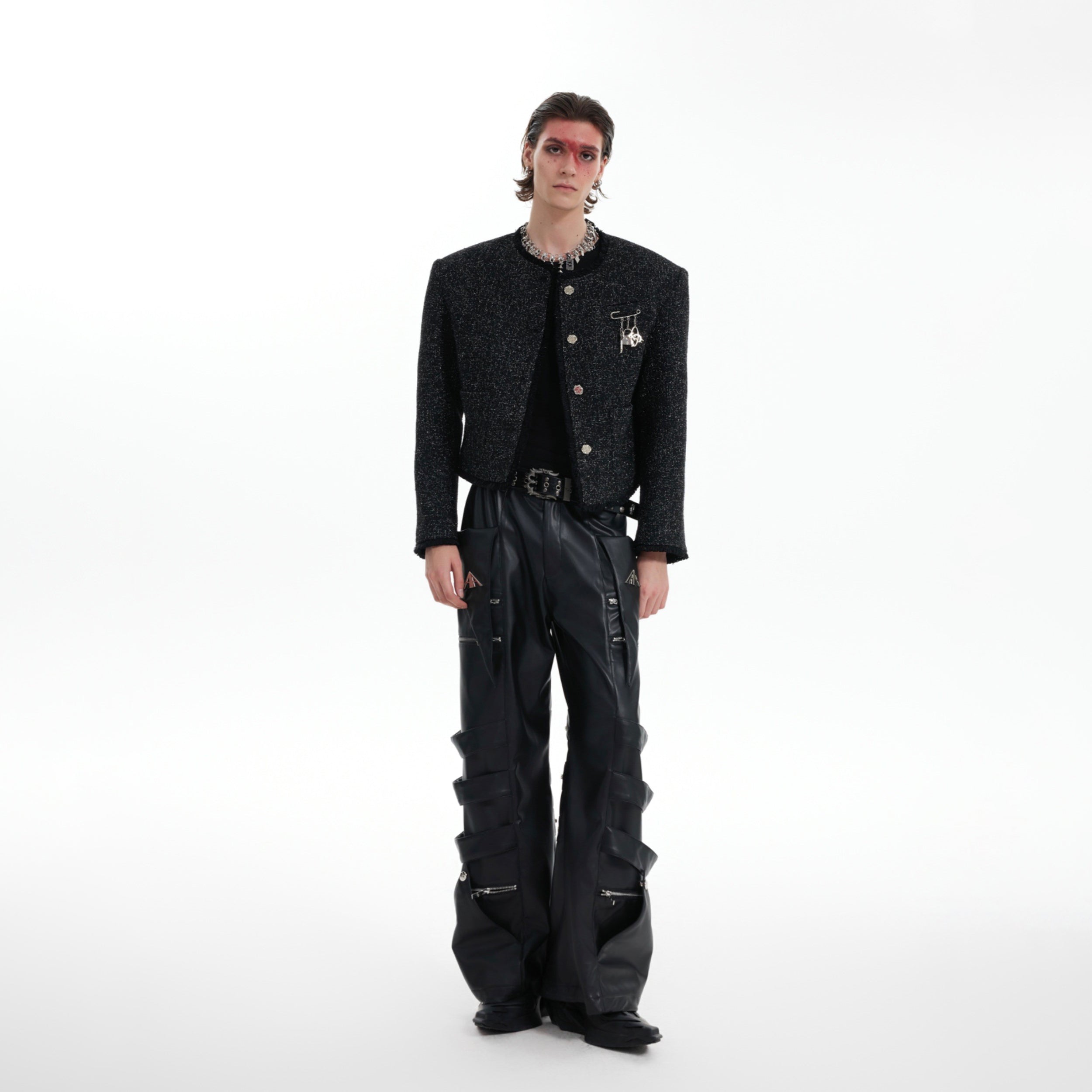 Front view of cropped deconstructed coat with dimensional detailing and modern silhouette