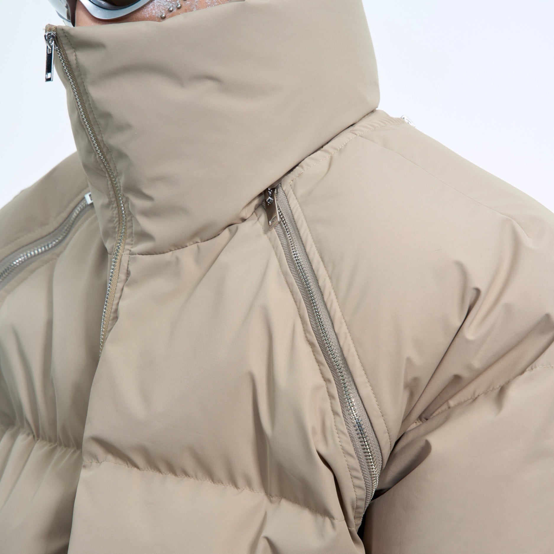 Back view of the heavyweight short puffer coat showing its deconstructed streetwear aesthetic