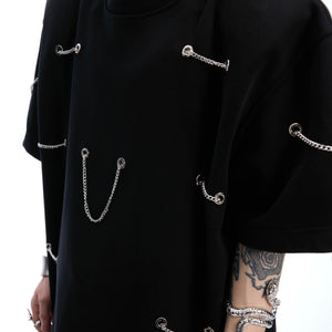 Back view of black streetwear t-shirt with unique chain accents and structured shoulder pad design