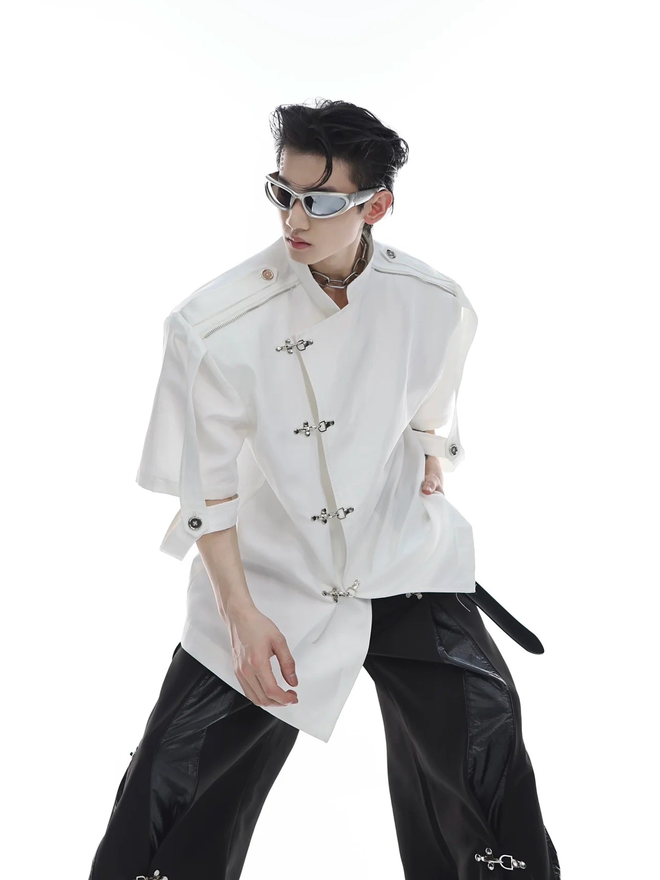 Front view of sleeveless mandarin-collar jacket with iridescent liquid metal fabric and statement buttons