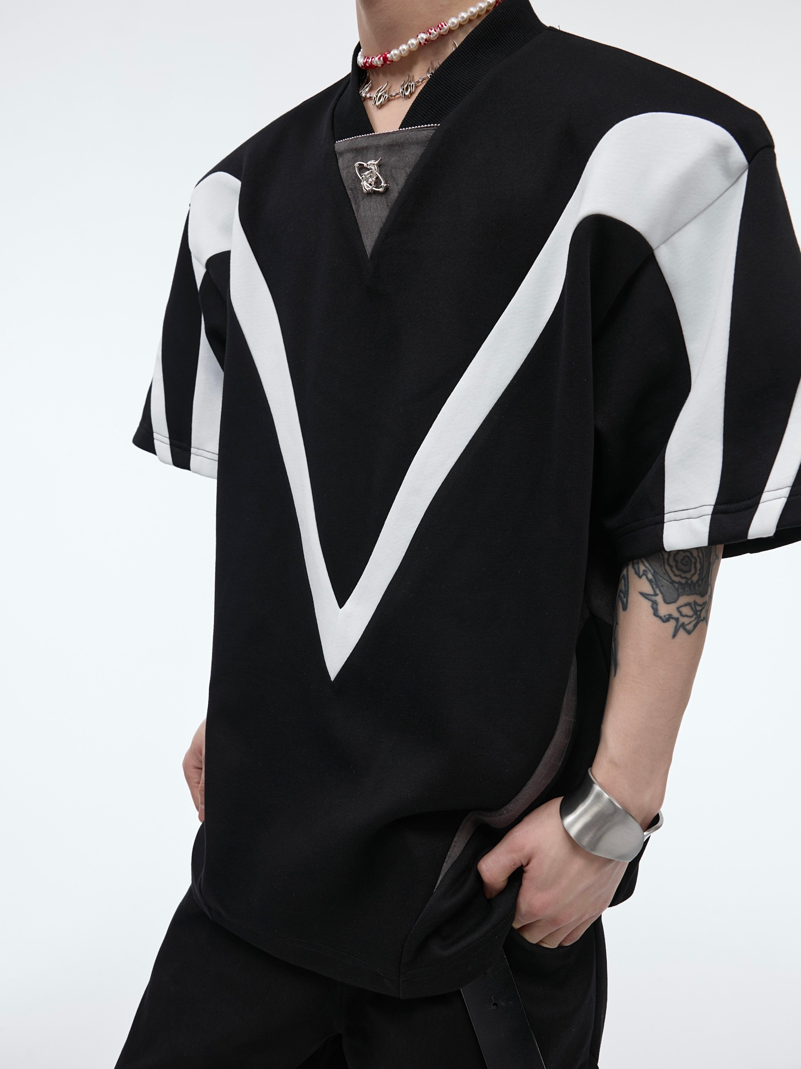 Flat lay display showing the full geometric line splits and asymmetrical design of this summer streetwear essential