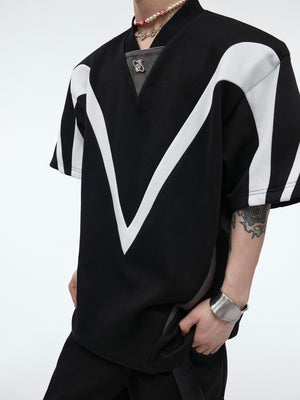 Flat lay display showing the full geometric line splits and asymmetrical design of this summer streetwear essential