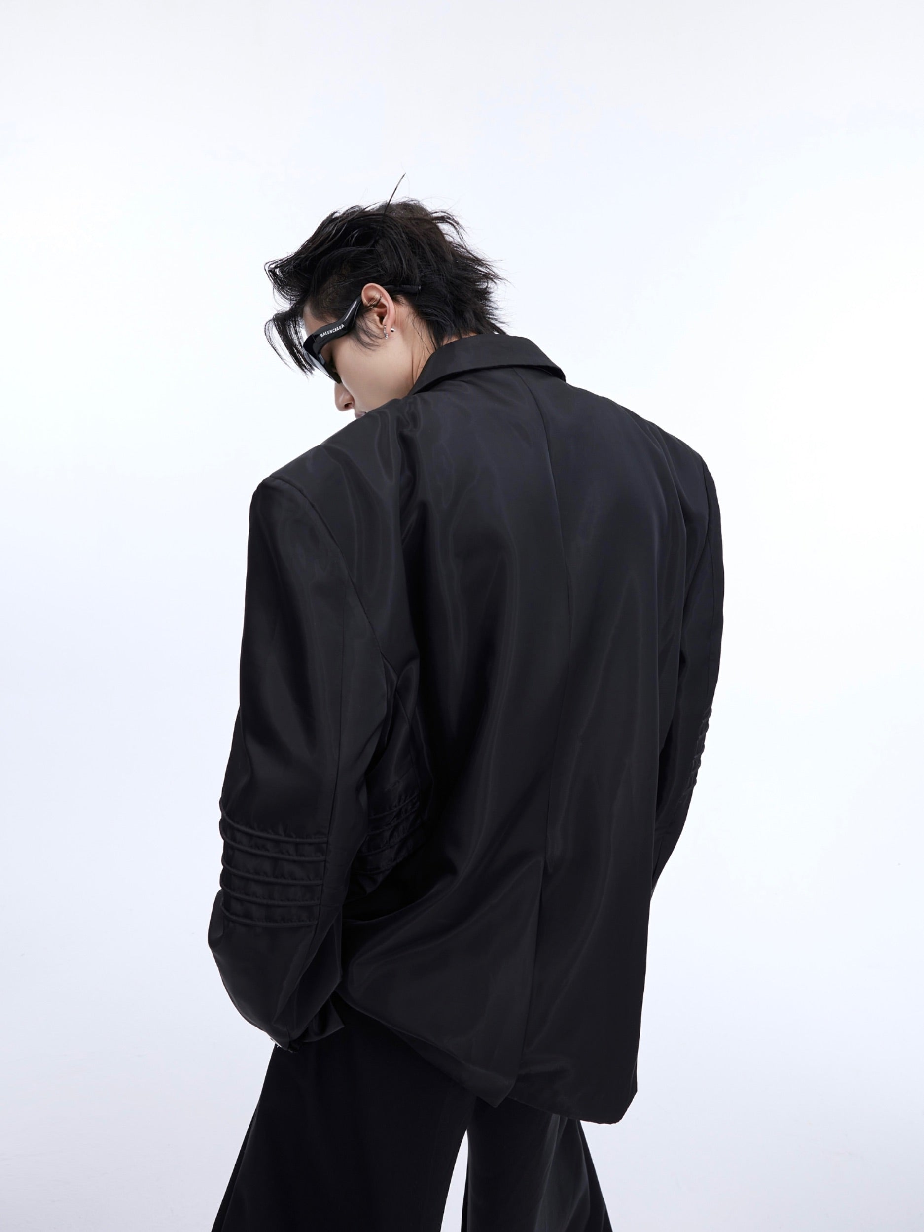 Side angle showing metallic accents and unique deconstructed design of this wrinkle-free blazer jacket