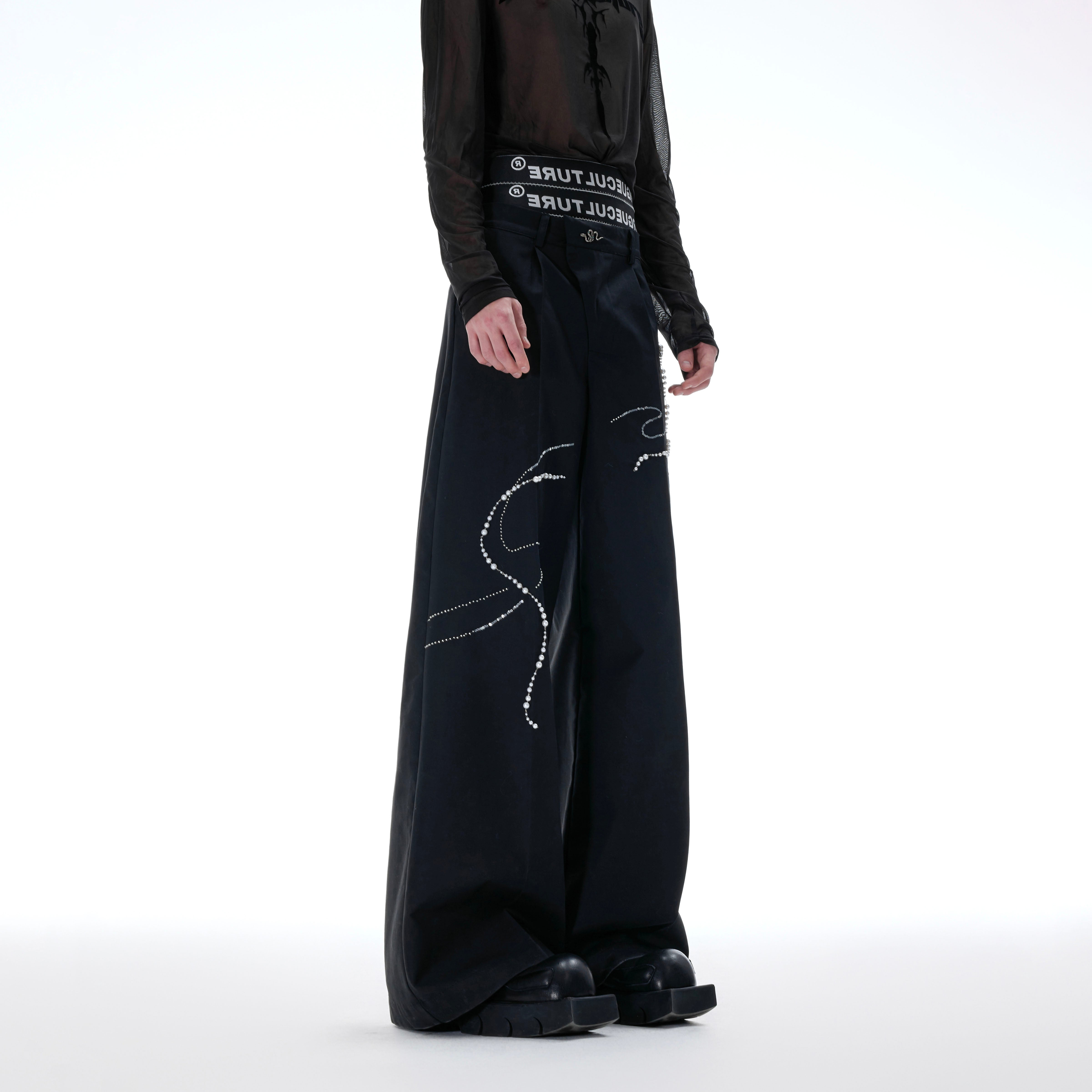 Model wearing snake year beaded pants from side view, showcasing premium breathable fabric and wide leg silhouette