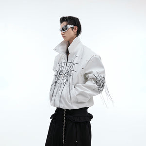 Close-up detail of metal studs and spiderweb fringe on this statement-making punk leather jacket