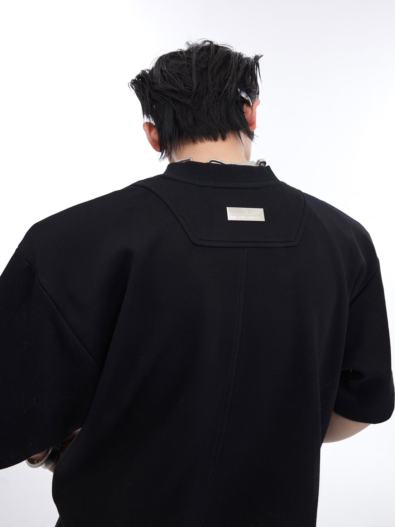 Detailed back view of the reconstructed t-shirt highlighting the innovative splicing technique and edgy streetwear look