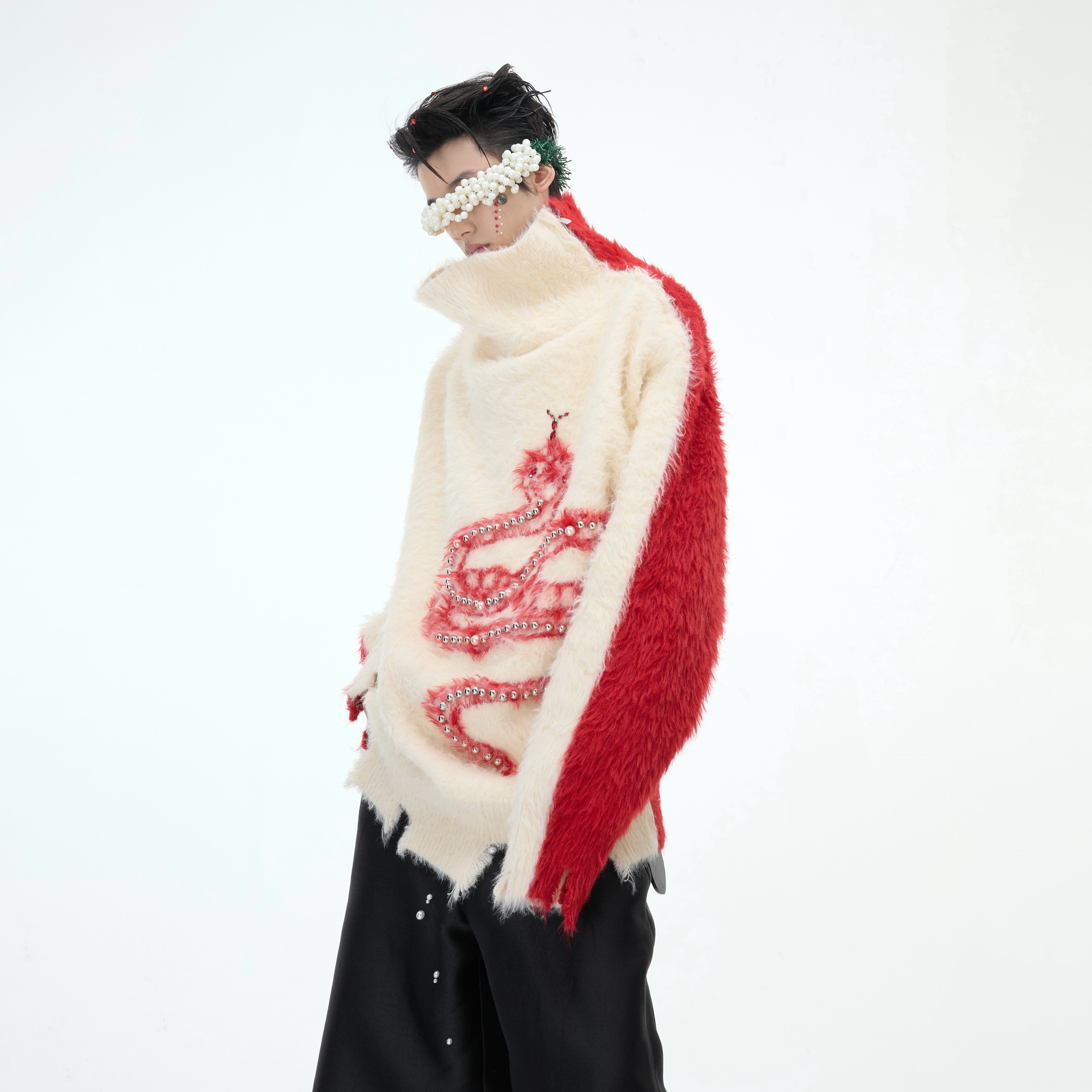 Fashion-forward split-neck sweater with unique irregular slit hem and snake embellishments