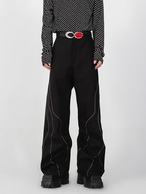 Black split-seam trousers with deconstructed tailoring detail, loose straight-leg fit for urban streetwear style