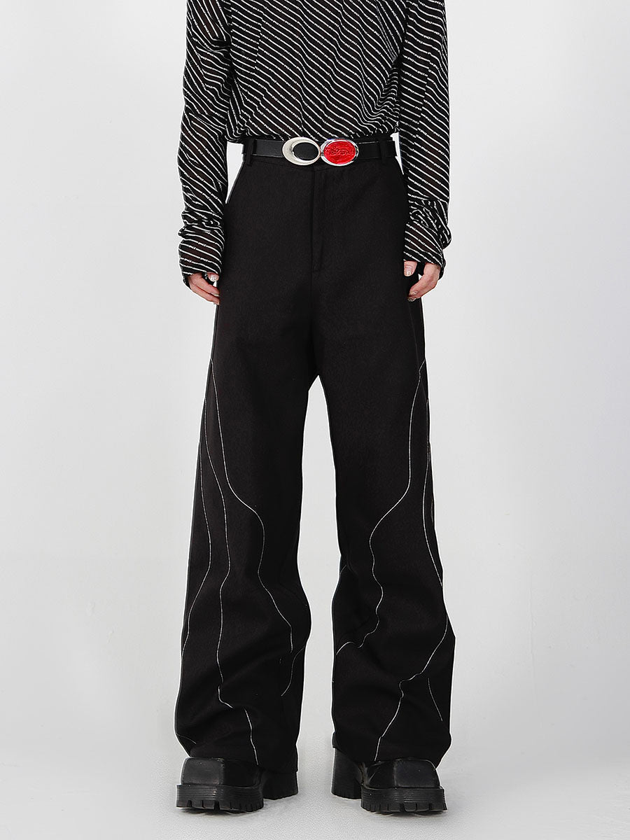 Black split-seam trousers with deconstructed tailoring detail, loose straight-leg fit for urban streetwear style