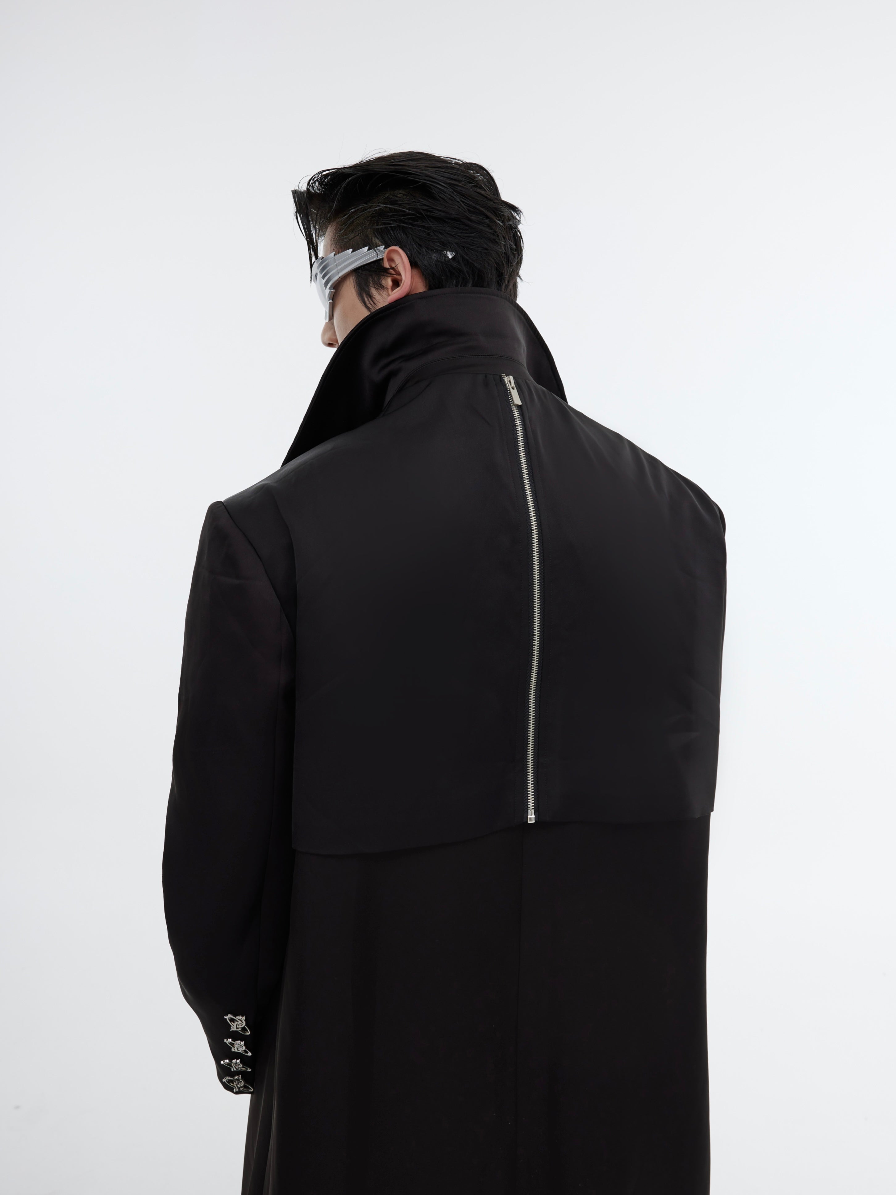 Back view of the avant-garde deconstructed trench coat highlighting its unique silhouette and design elements