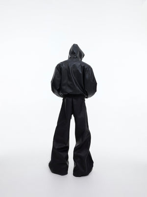 Back view of deconstructed leather trousers highlighting the straight-leg silhouette